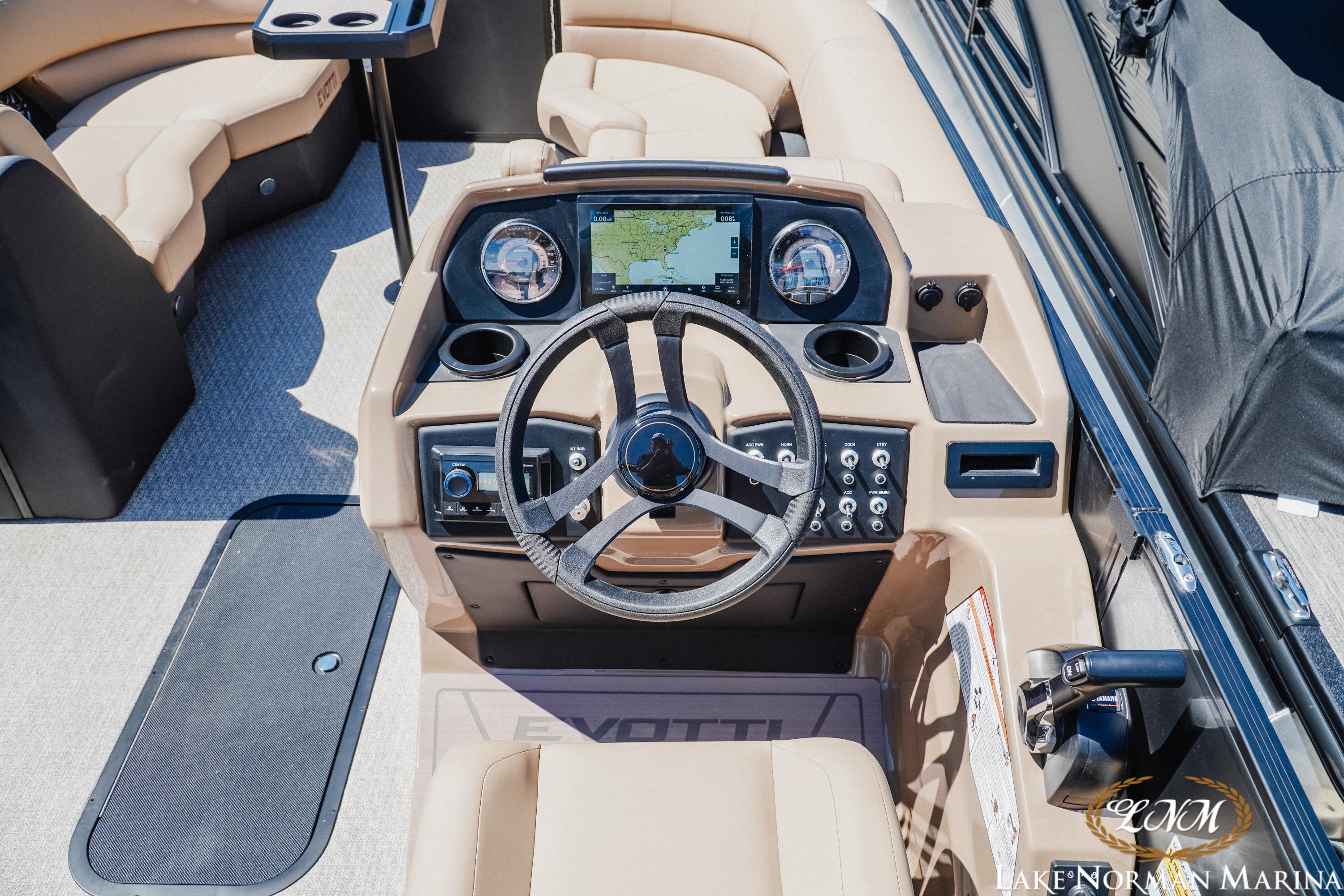 2026 Evotti 523CS boat dashboard with steering wheel and navigation display.