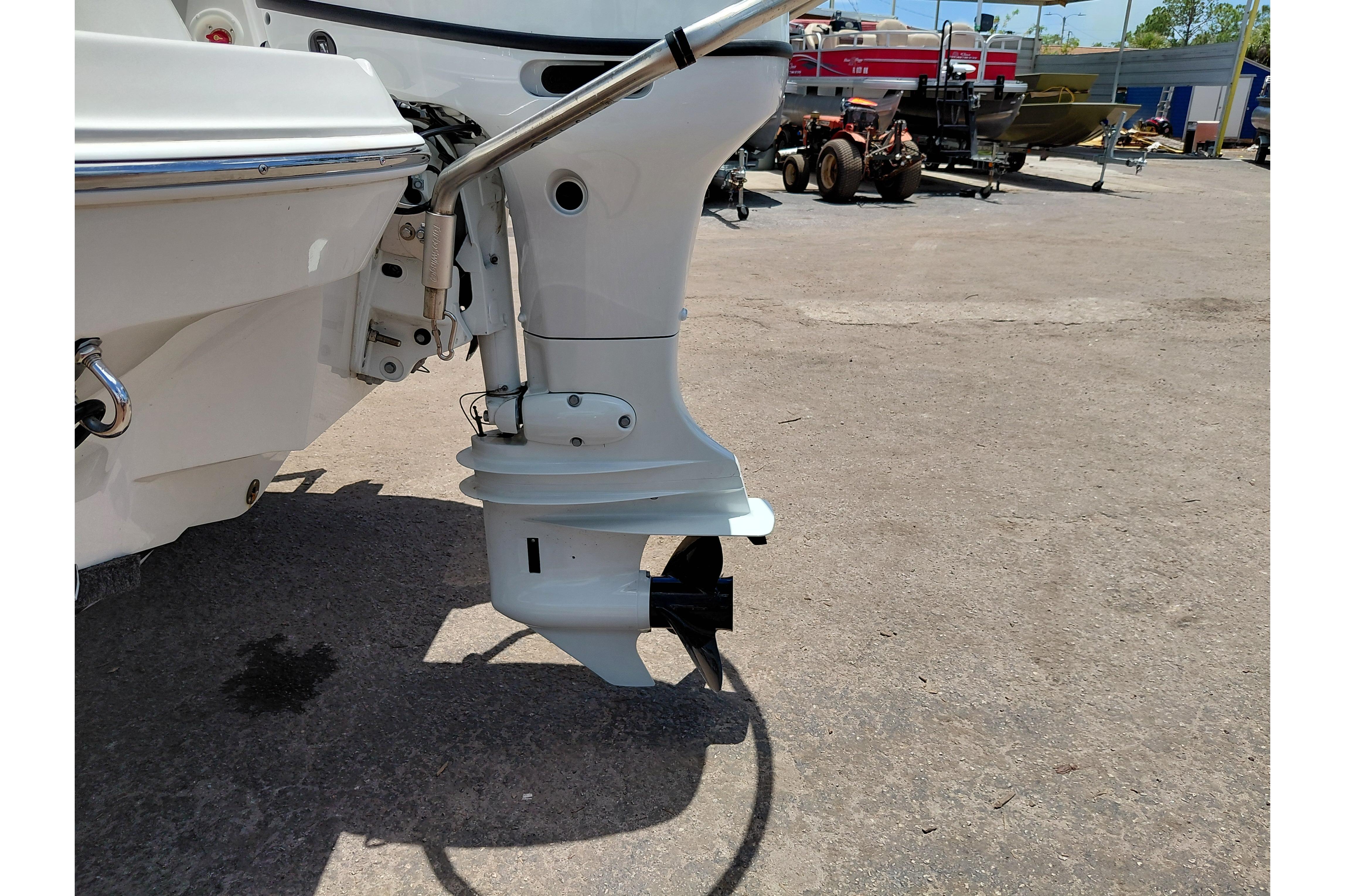 2023 Stingray 206 CC boat motor and propeller in a marina setting.