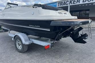 2017 Bayliner 195 Deck Boat on trailer, parked outdoors near a Tracker Boats sign.