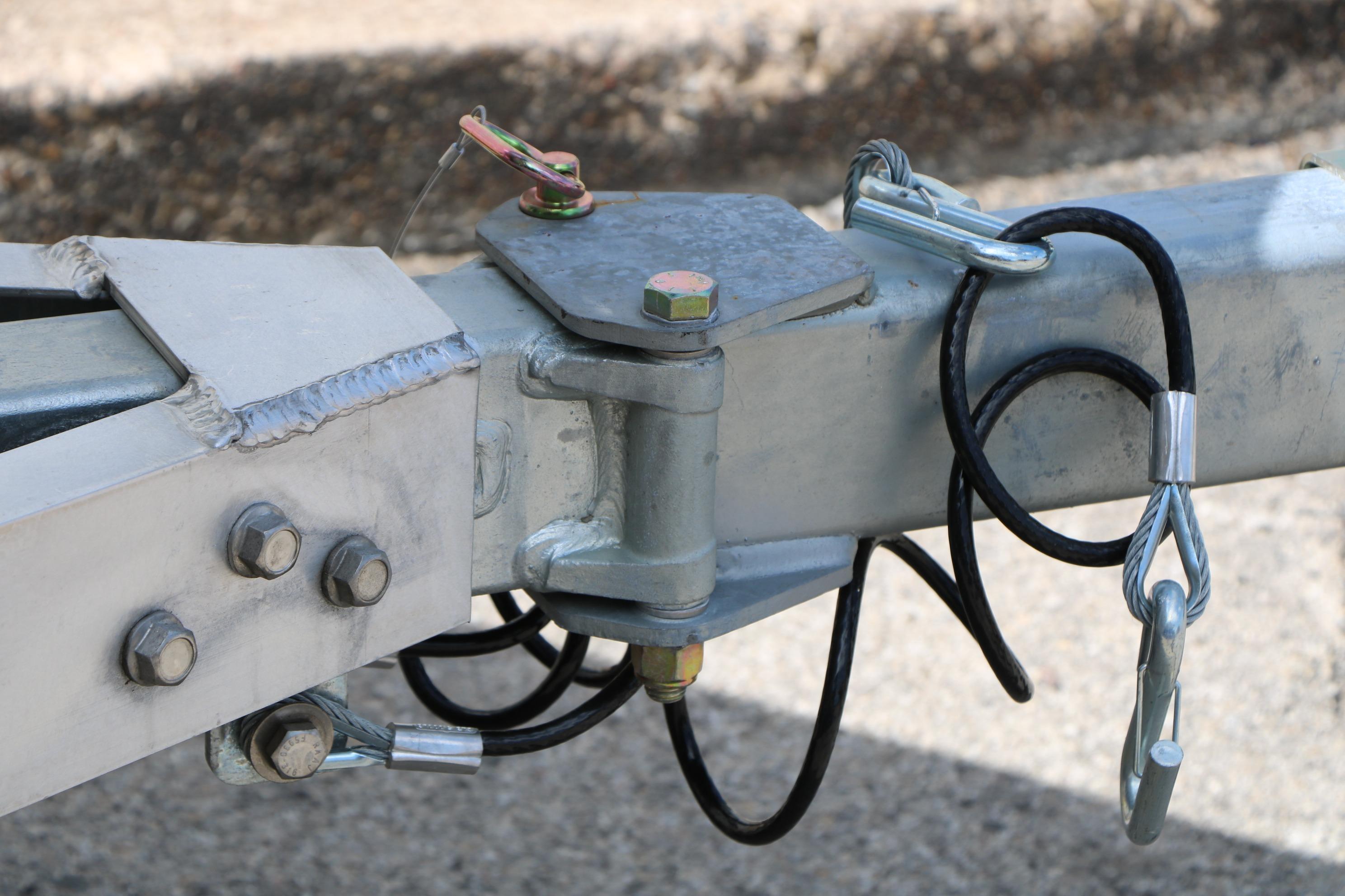 Trailer hitch assembly of 2026 Vexus Defender 201 with safety cables and bolts.