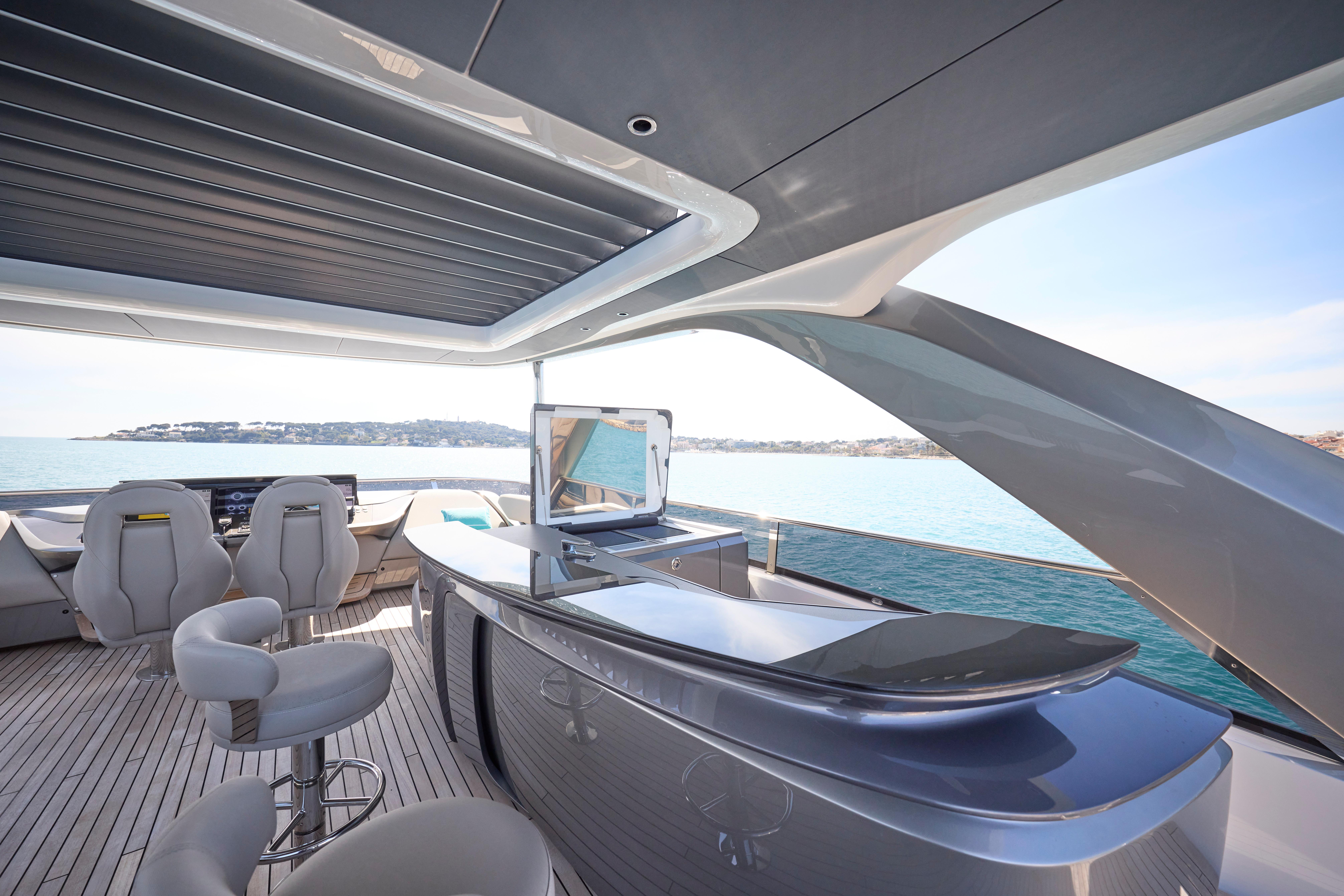 Luxurious 2024 Princess Y85 yacht interior with sleek bar and ocean view.