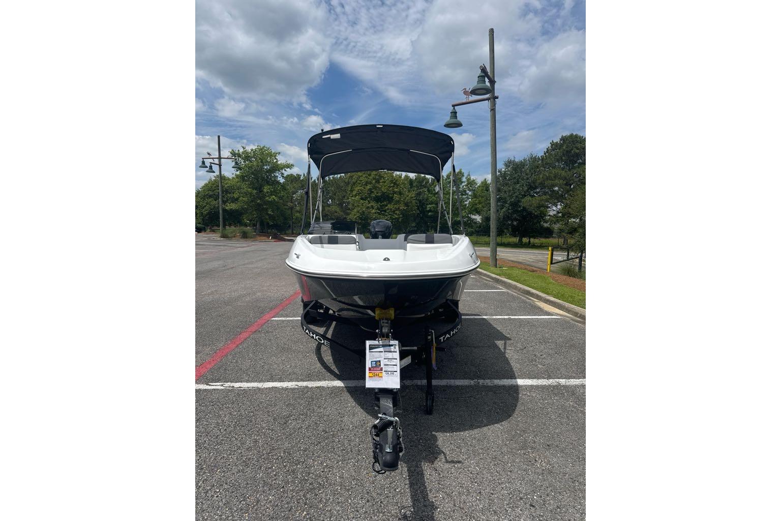 2026 Tahoe T16 boat parked outdoors under a cloudy sky.