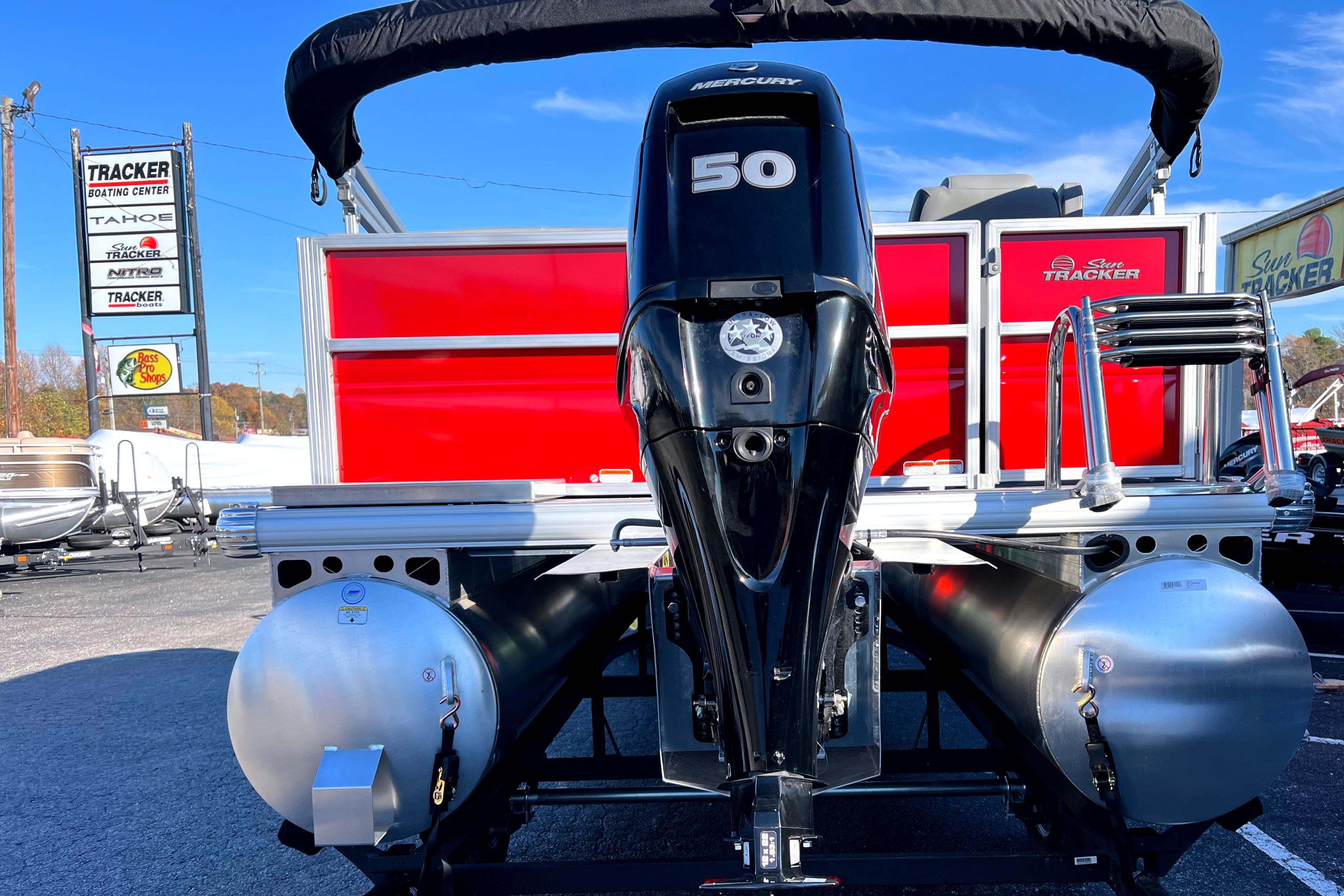 2026 Sun Tracker Party Barge 16 DLX with Mercury 50 engine at dealership.