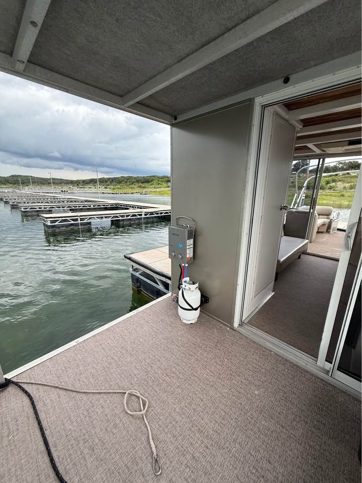 2008 Sun Tracker Party Cruiser on a lake with dock.