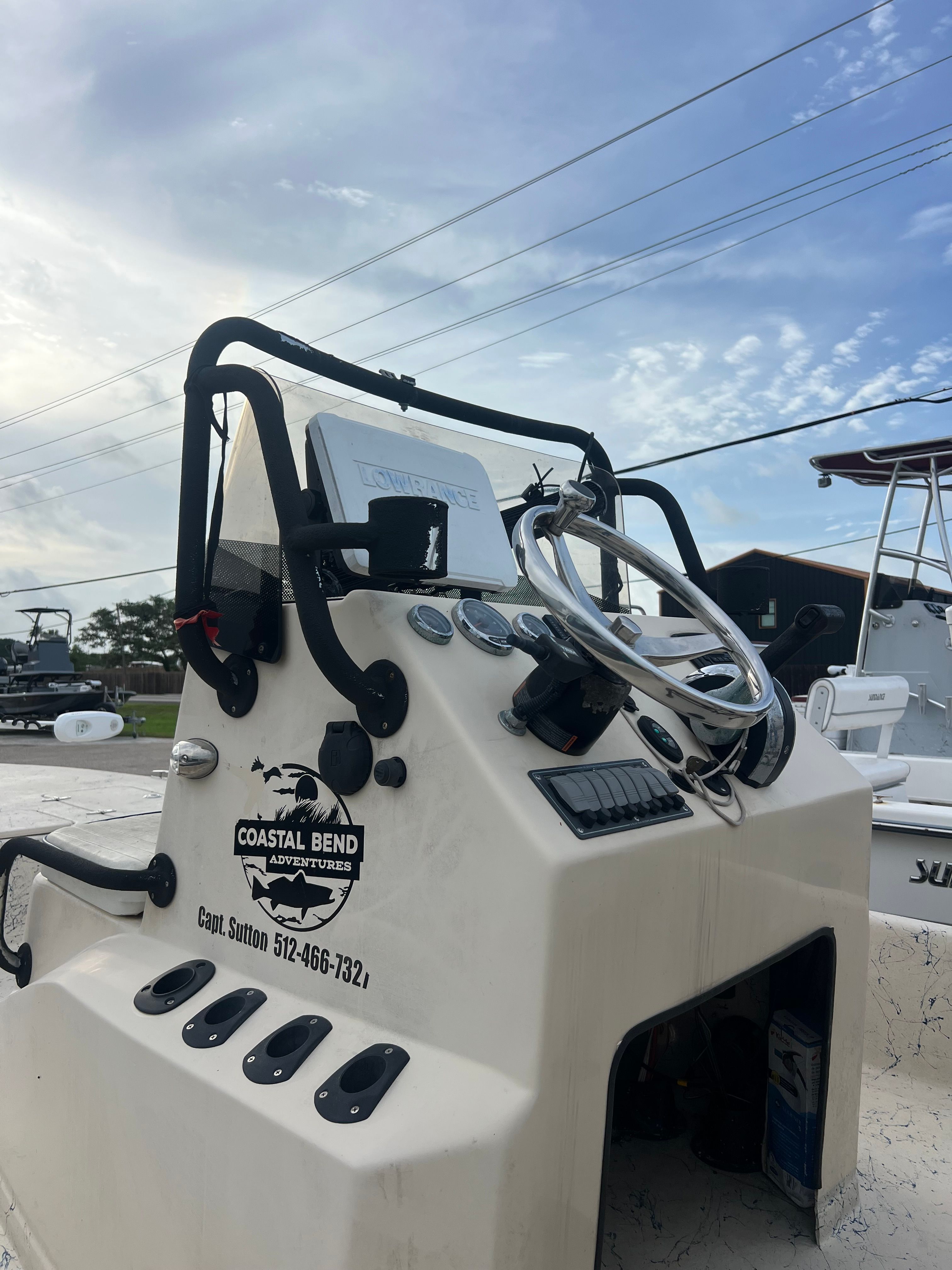 2014 Haynie ho with steering console and wheel, parked outdoors.