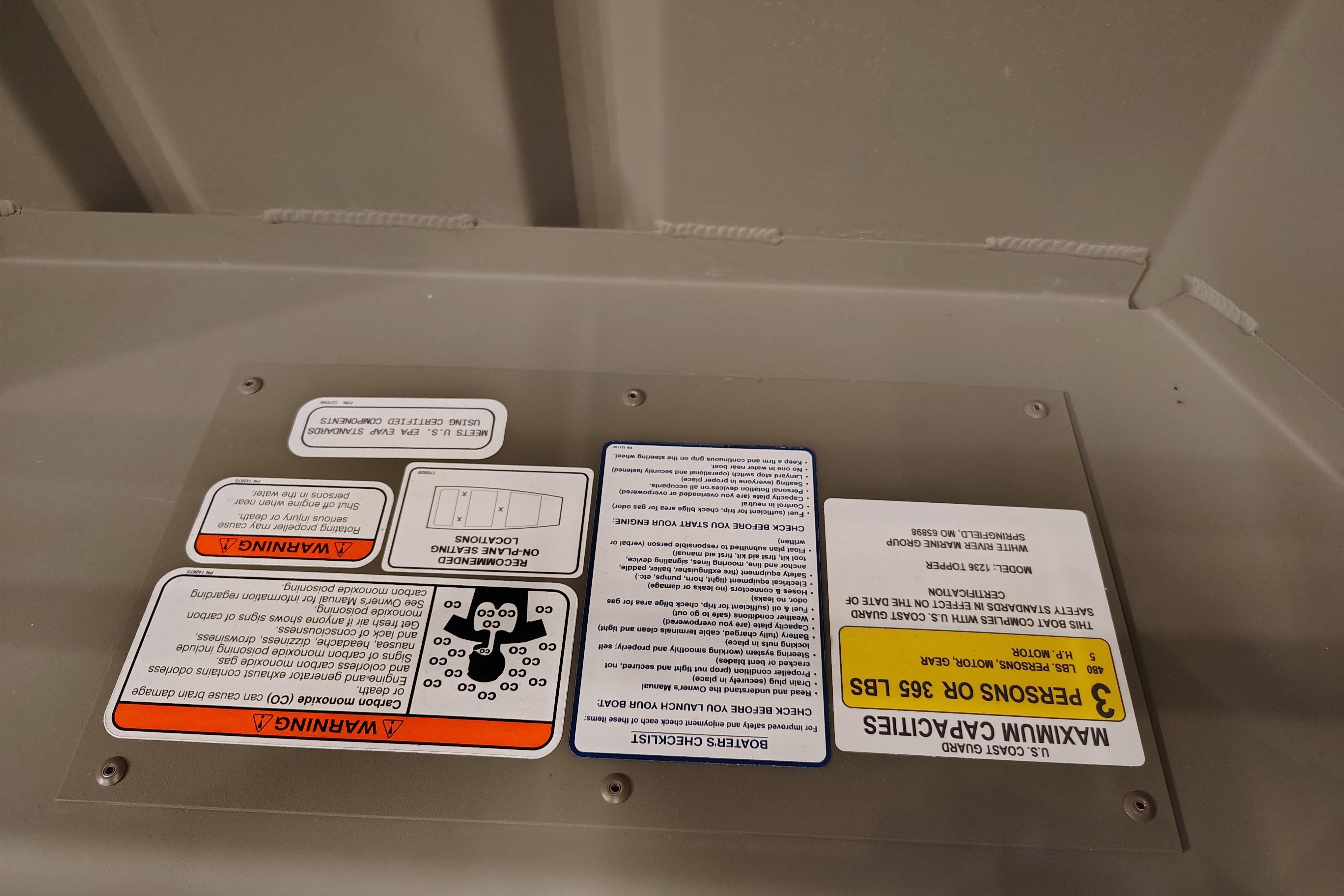Warning labels on 2026 Tracker Grizzly 12 Jon boat interior.