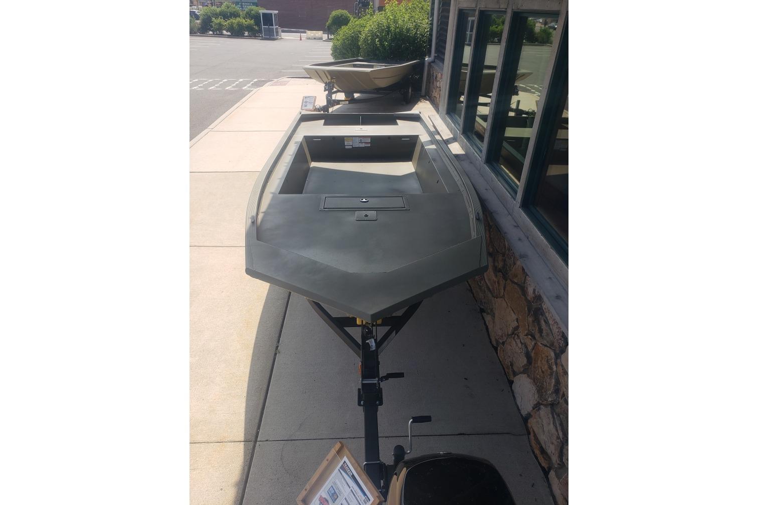 2026 Tracker Grizzly 1754 Utility boat on trailer, parked outdoors.