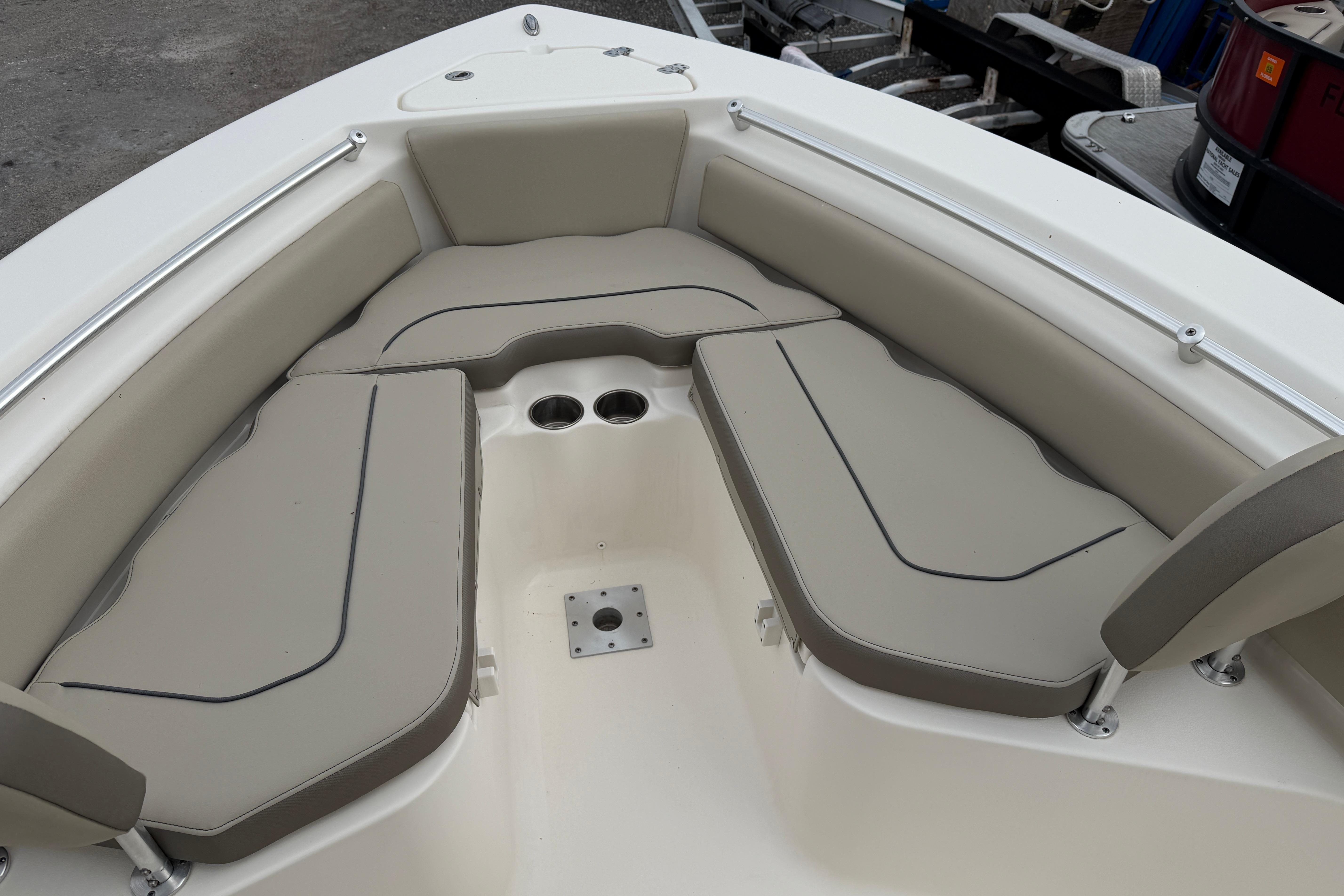 2022 Key West 219 FS boat interior with cushioned seating and cup holders.