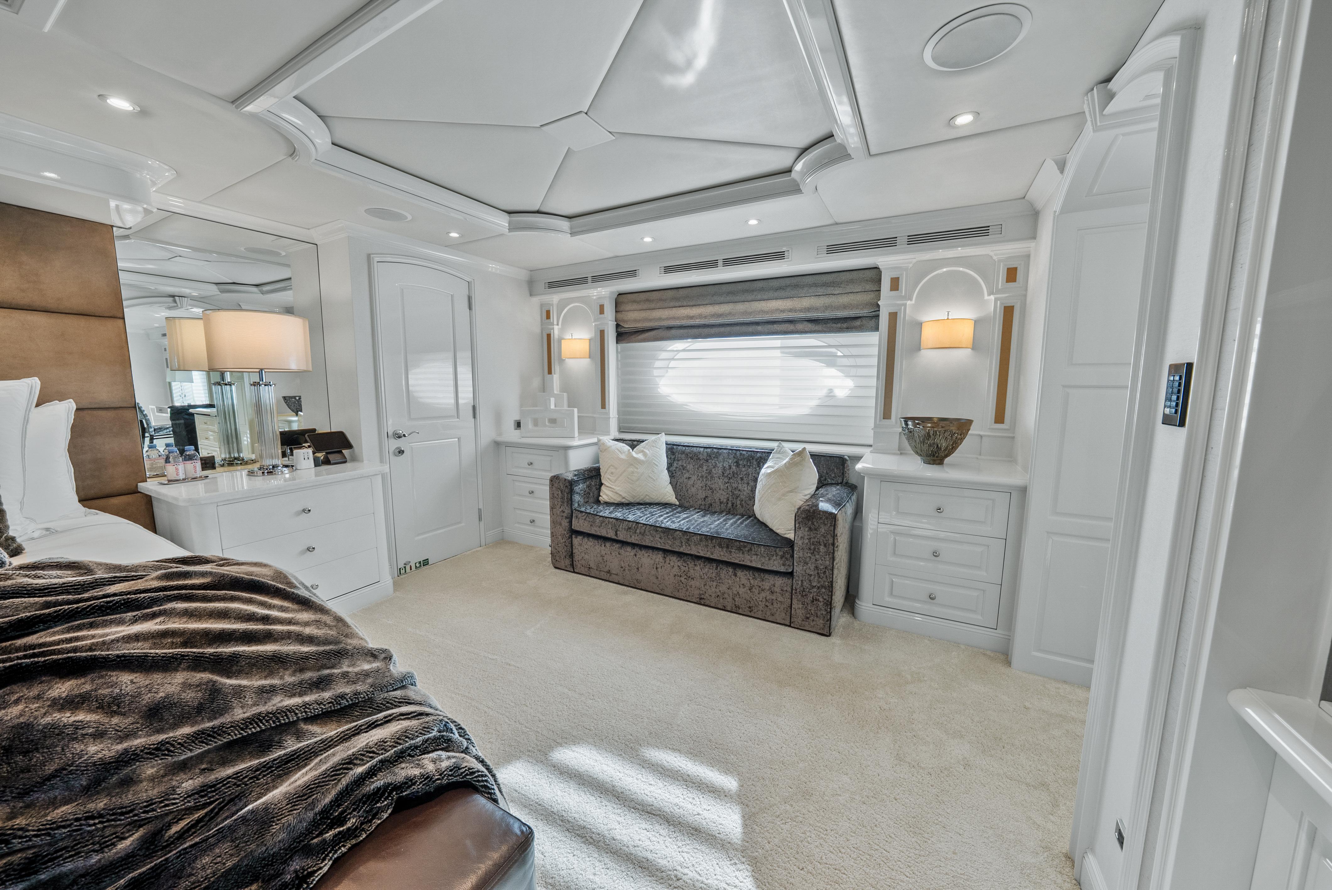 Luxurious bedroom interior on 2005 Trinity Yachts Tri-Deck, featuring elegant furnishings and soft lighting.