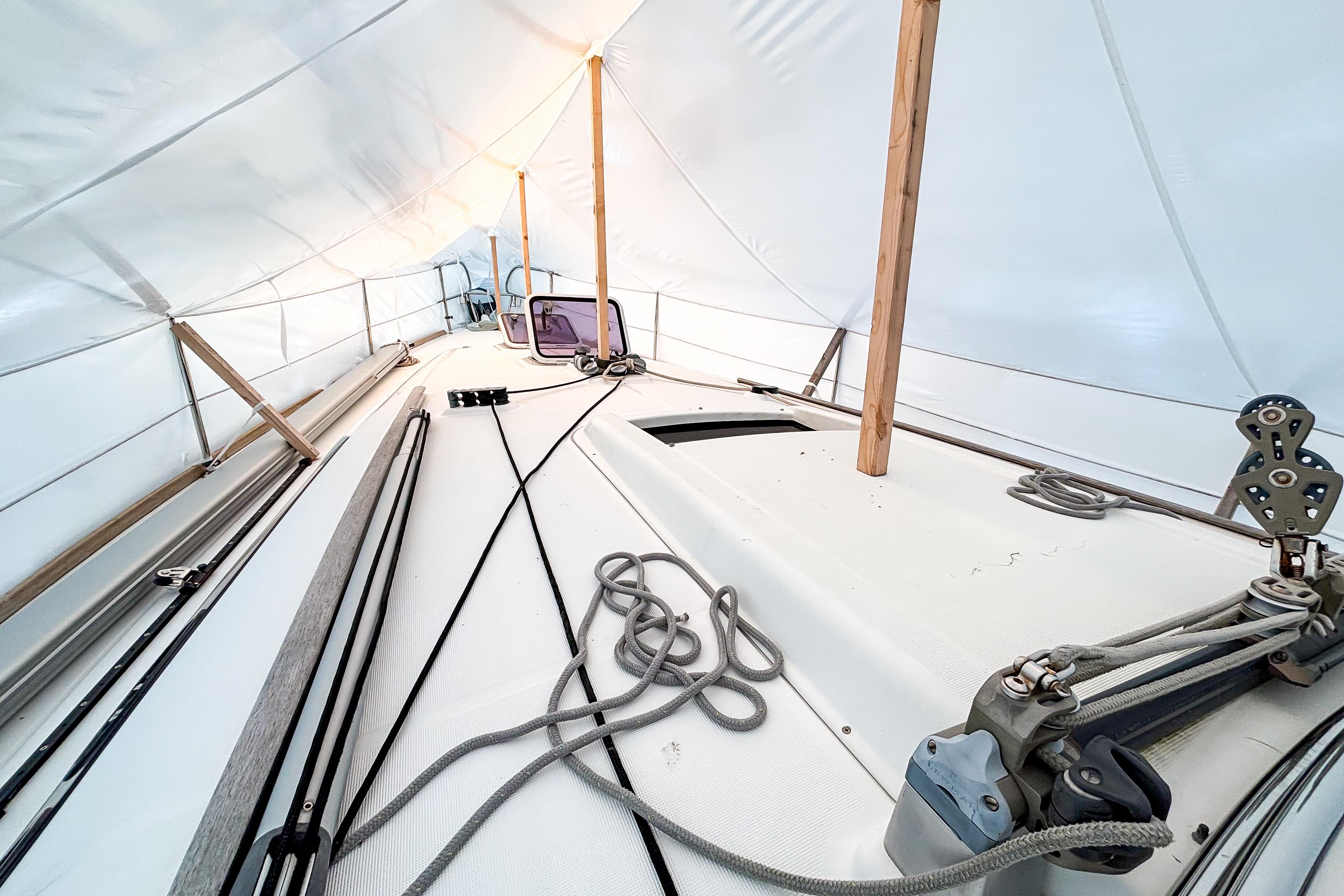 Beneteau Oceanis 37 sailboat deck under protective cover, showcasing rigging and ropes, 2015 model.