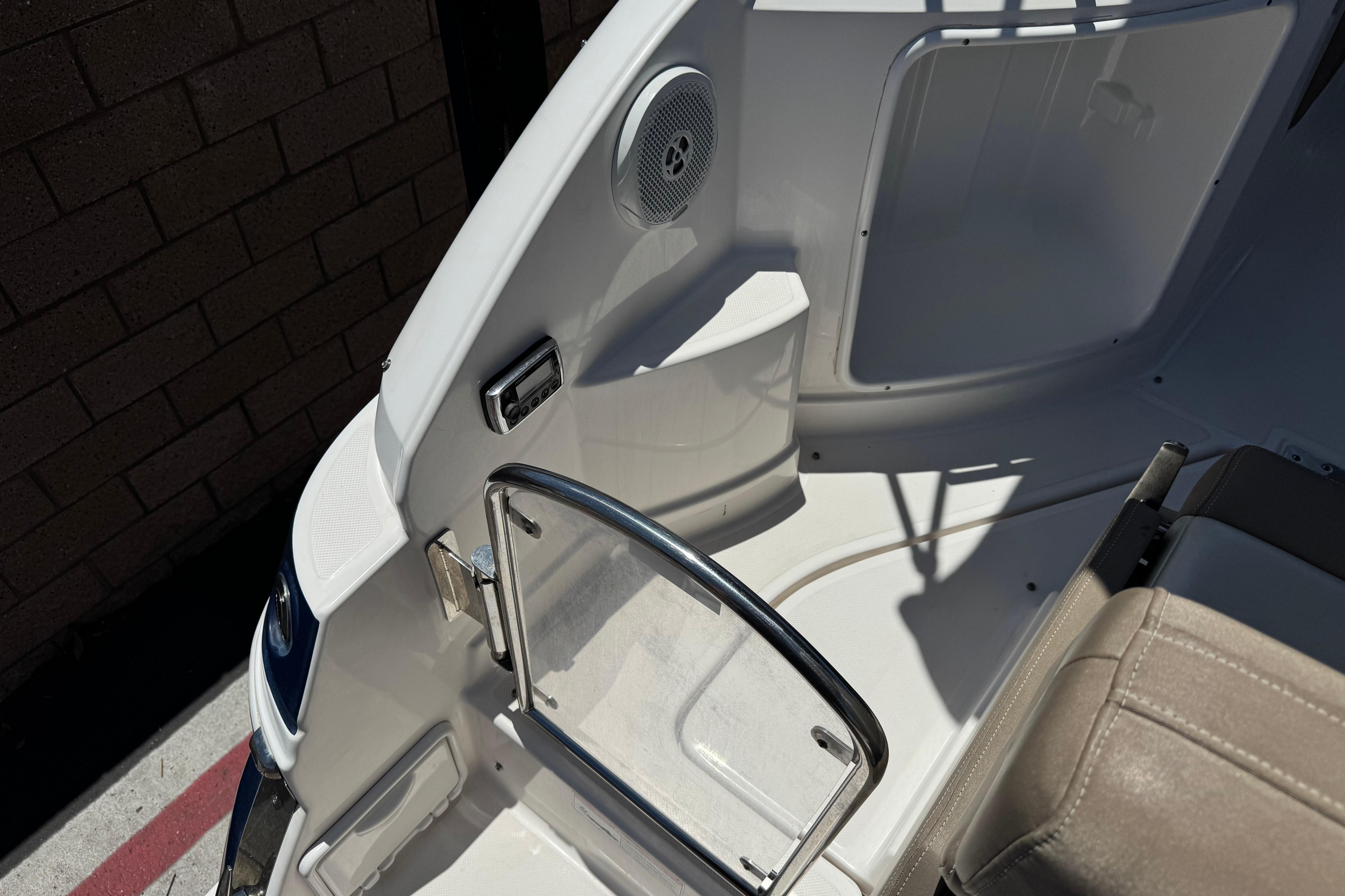 Interior view of a 2013 Regal 28 Express boat, featuring seating and a speaker.
