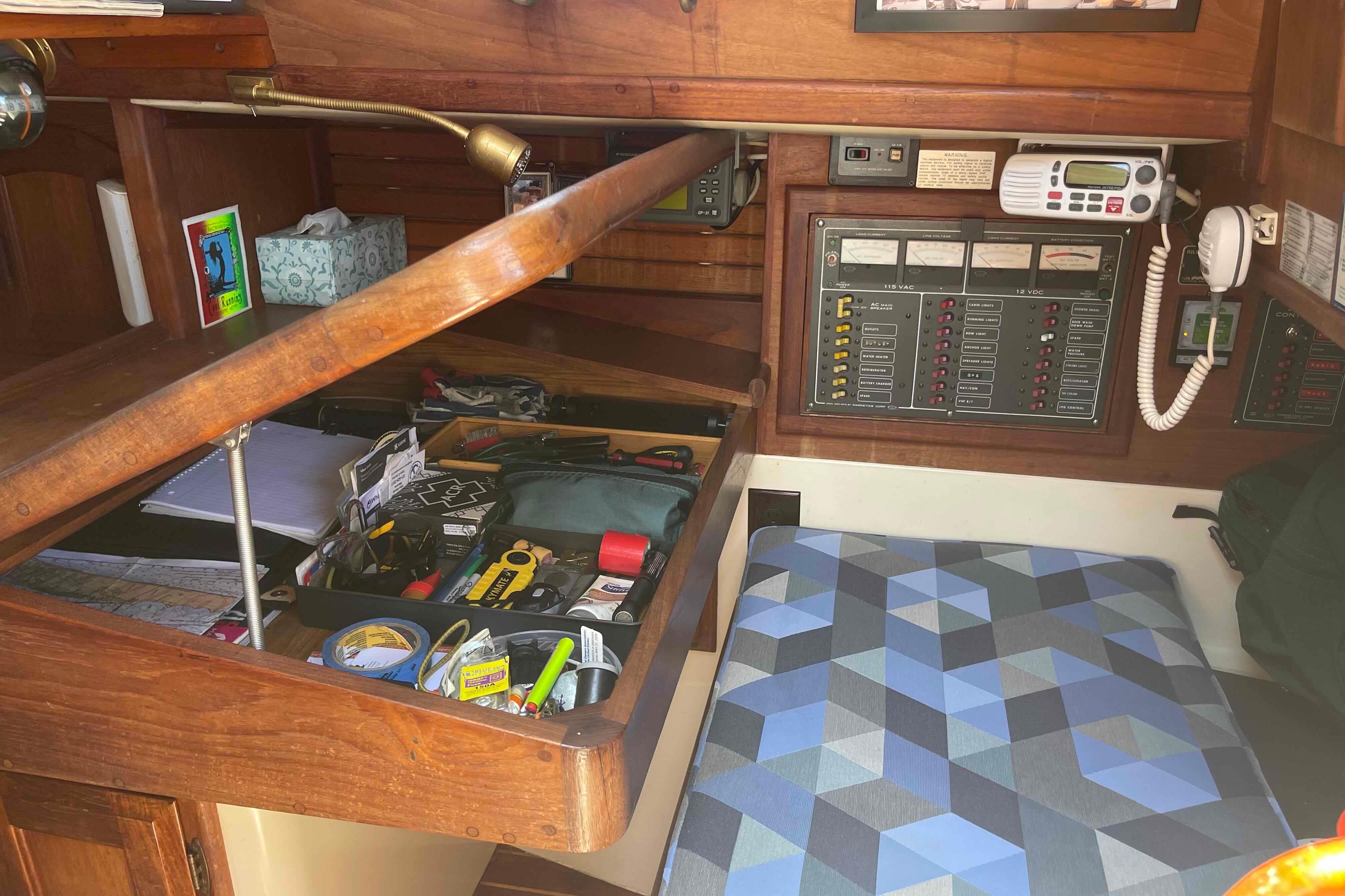 Interior of 1987 Pacific Seacraft 34 sailboat with navigation station and tools.