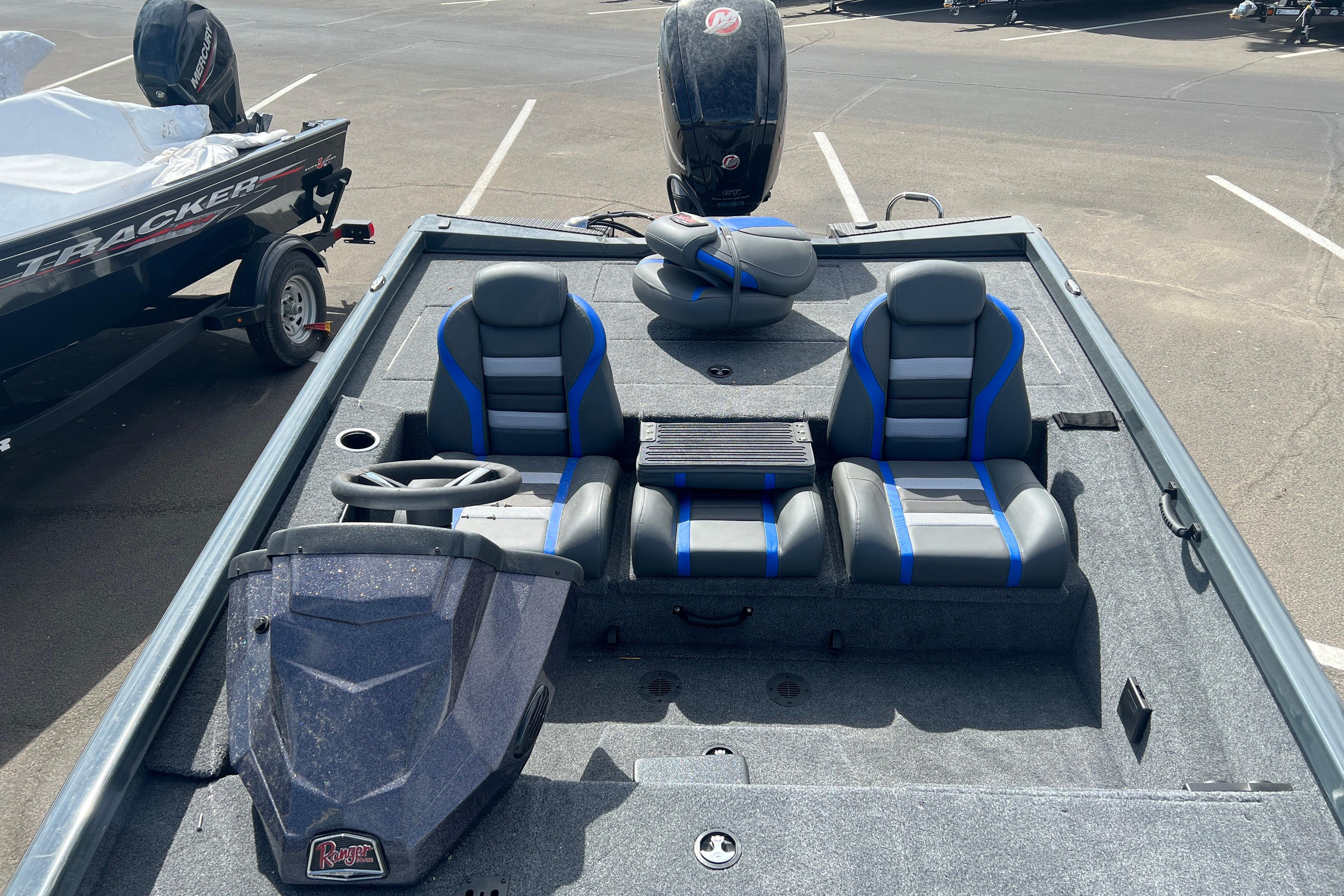 2026 Ranger RT188P boat interior with dual seats and steering wheel in a parking lot.