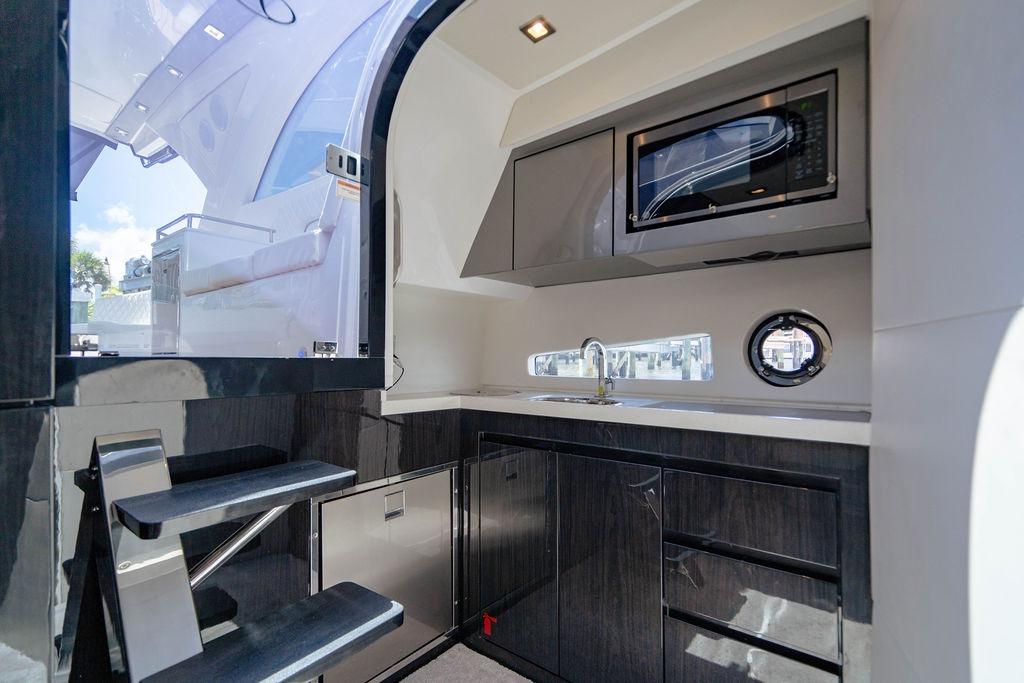 Modern kitchen interior of 2022 Schaefer 400 Sport yacht with sleek cabinetry and appliances.