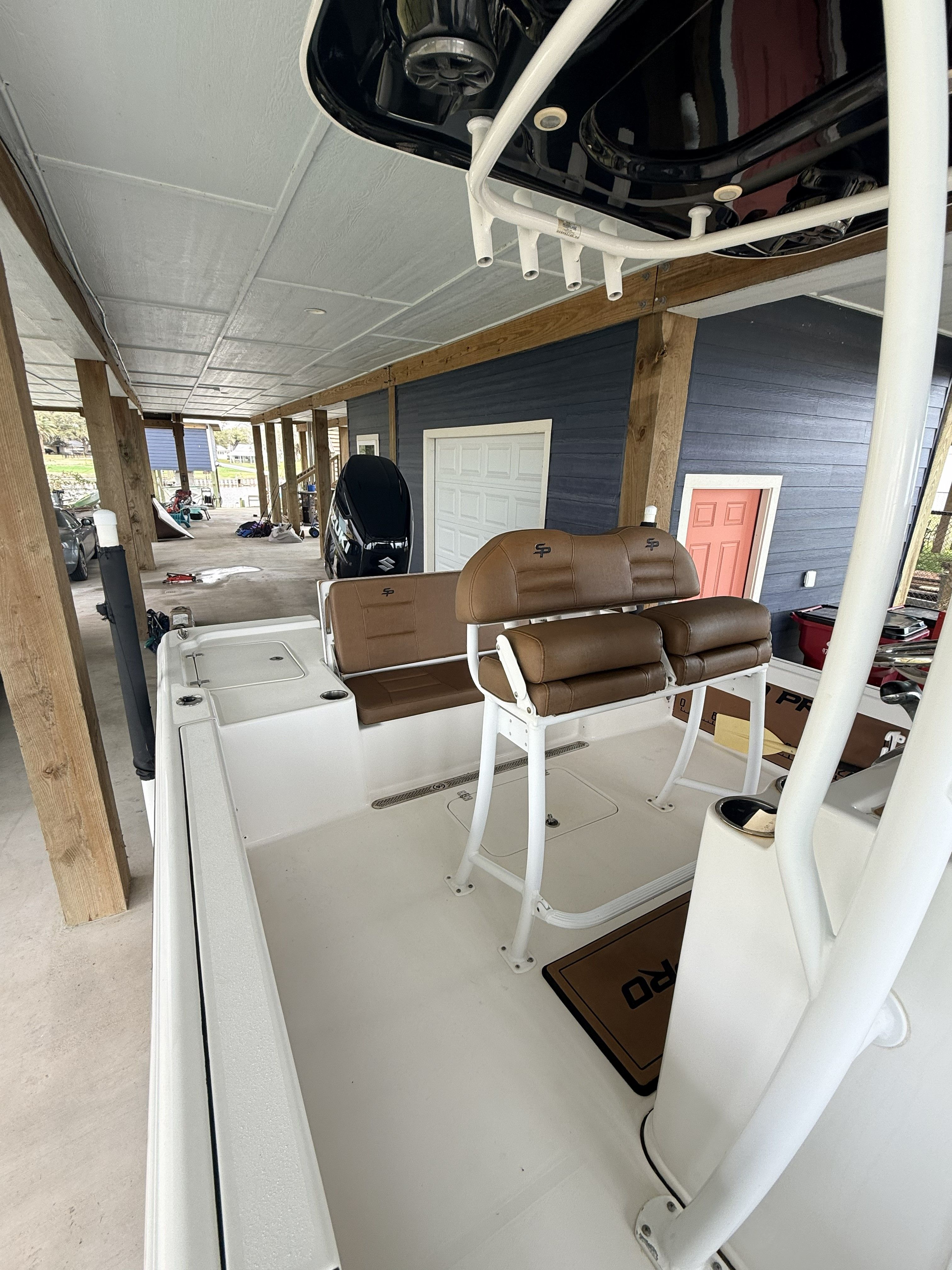 A 2018 Sea Pro 248 Bay boat is under a covered area.