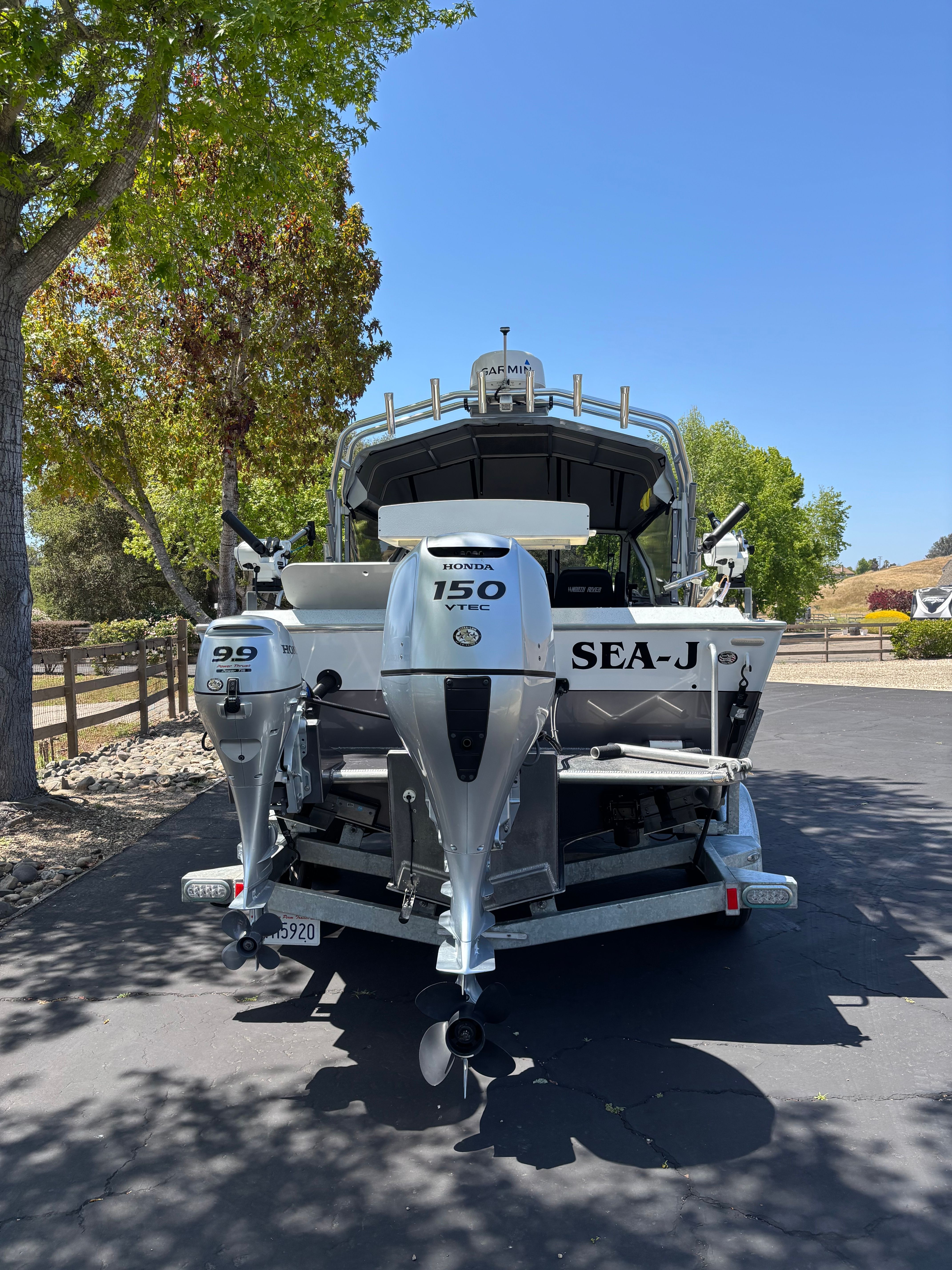 2020 Sea Hawk North River boat with Honda engines parked outdoors.