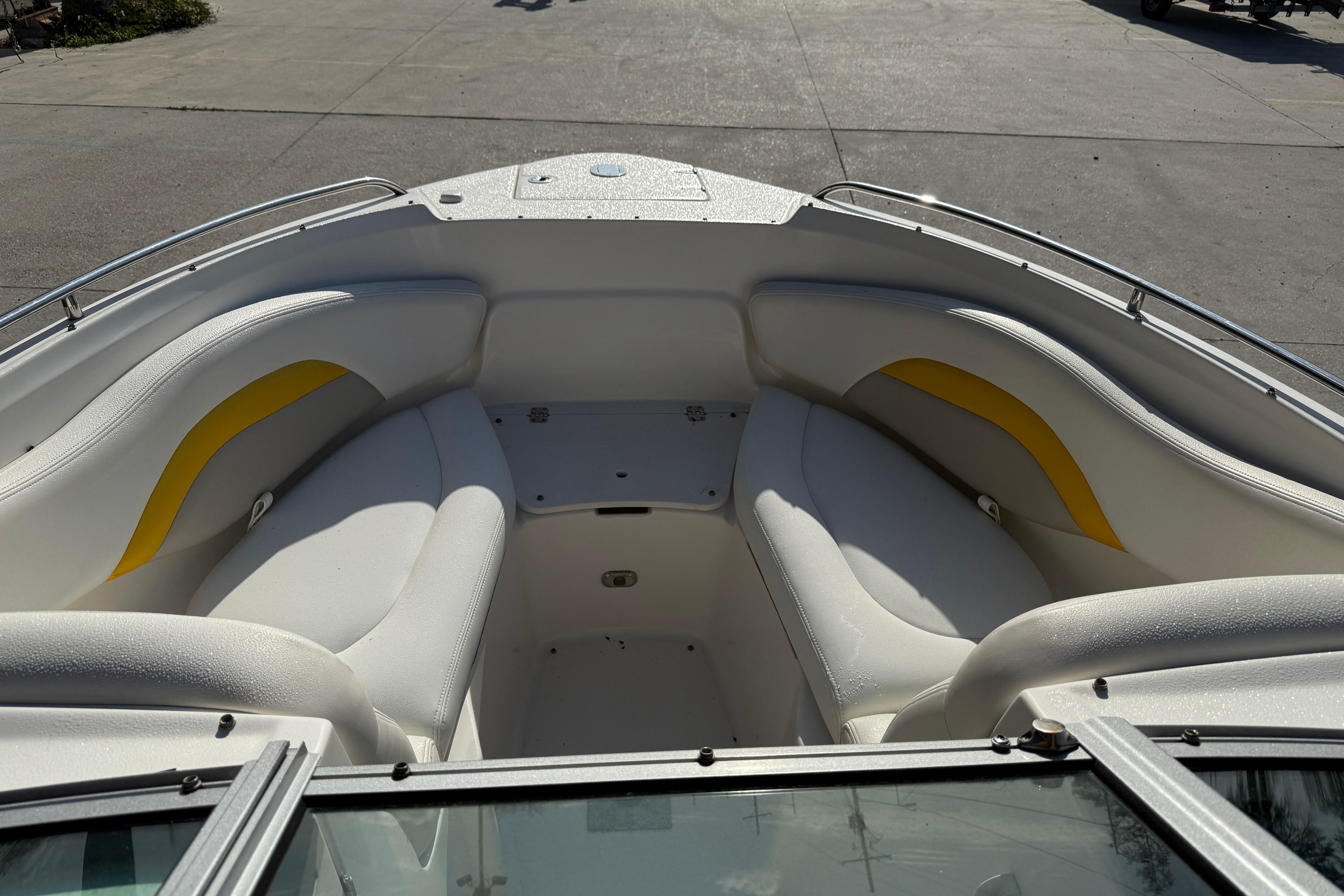 2008 Chaparral 236 SSX boat interior with white and yellow seating.