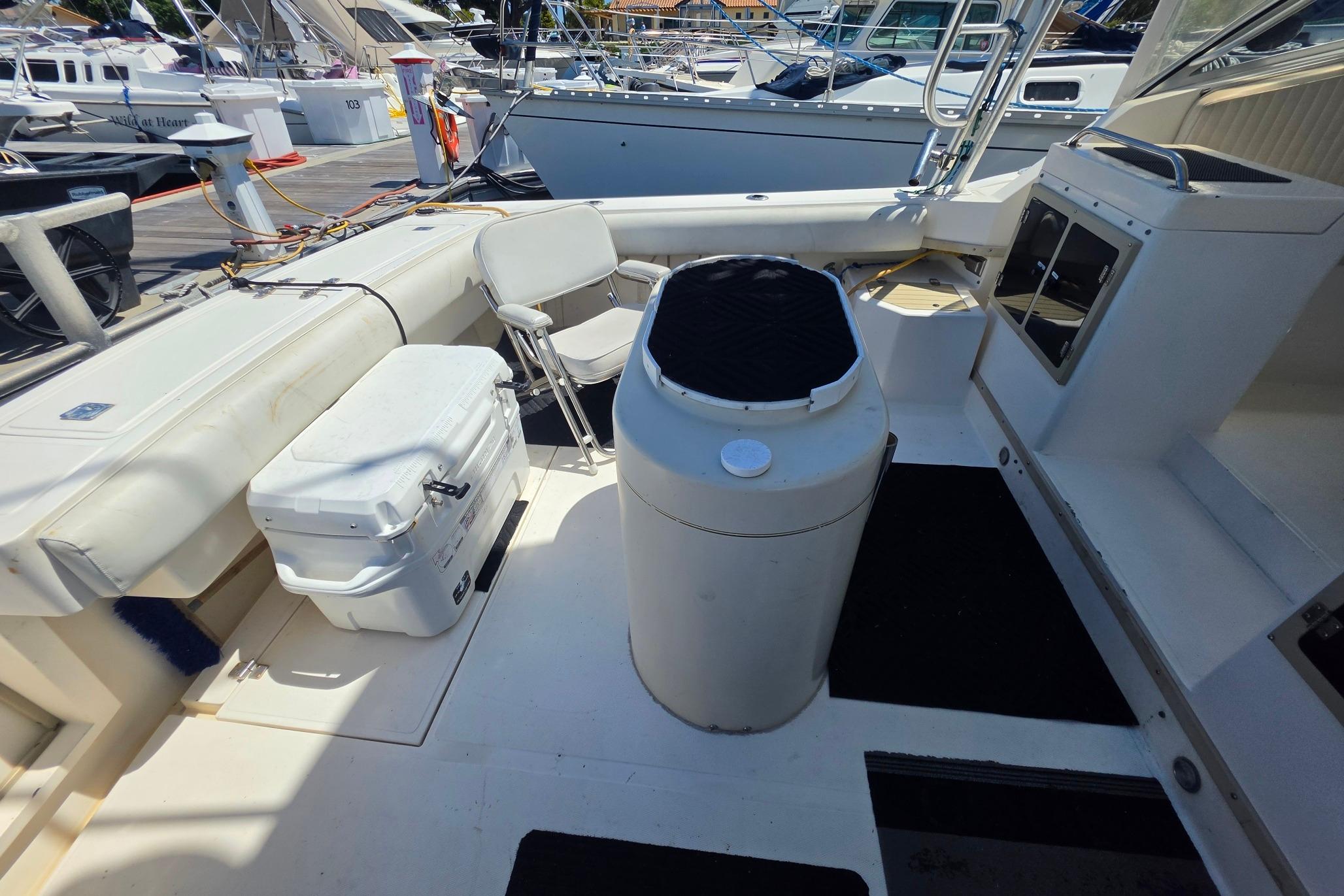 1999 Albemarle 305 Express Fisherman boat deck with seating and storage.