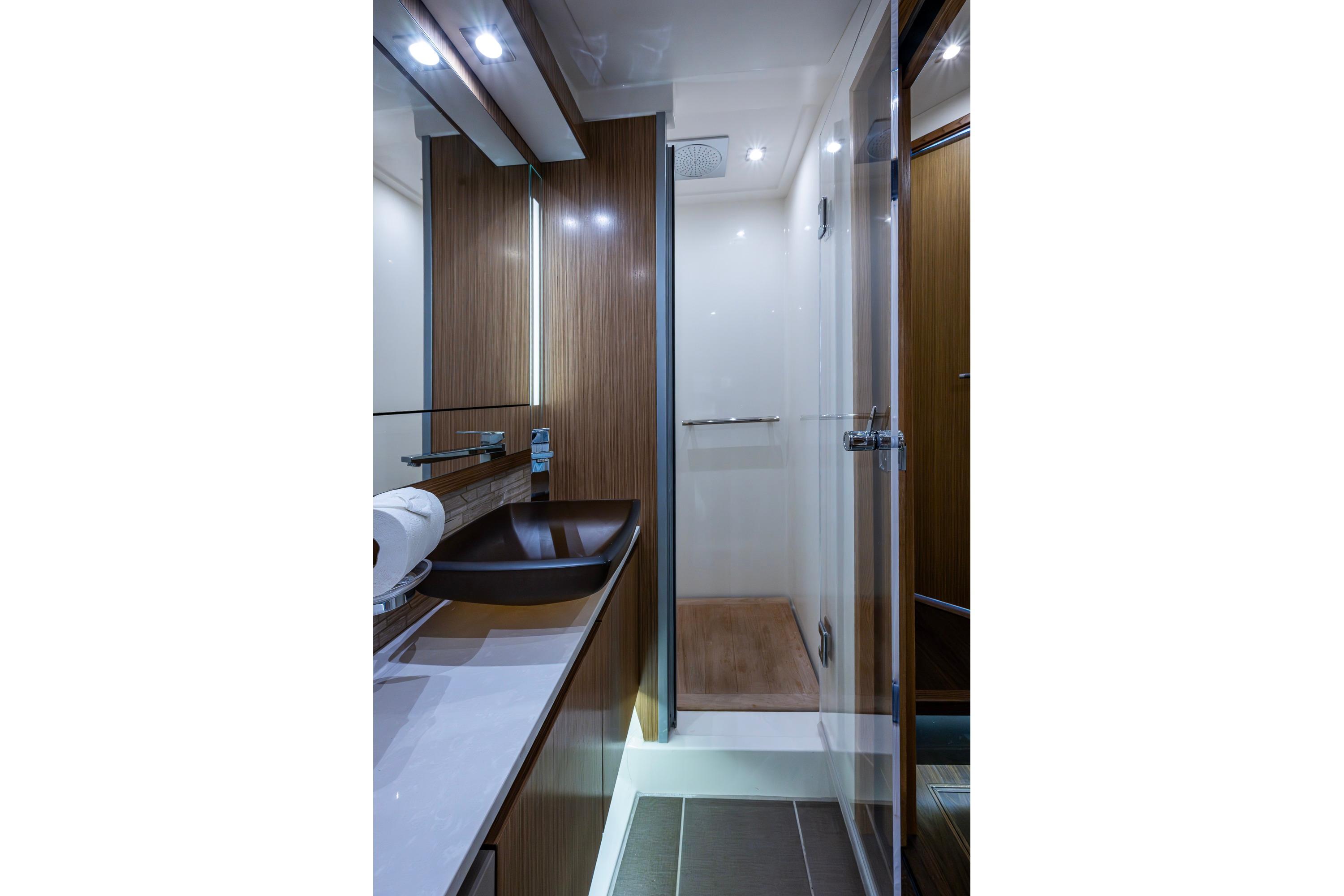 Luxurious bathroom interior of 2018 Sea Ray L550 Fly yacht, featuring modern fixtures and elegant design.