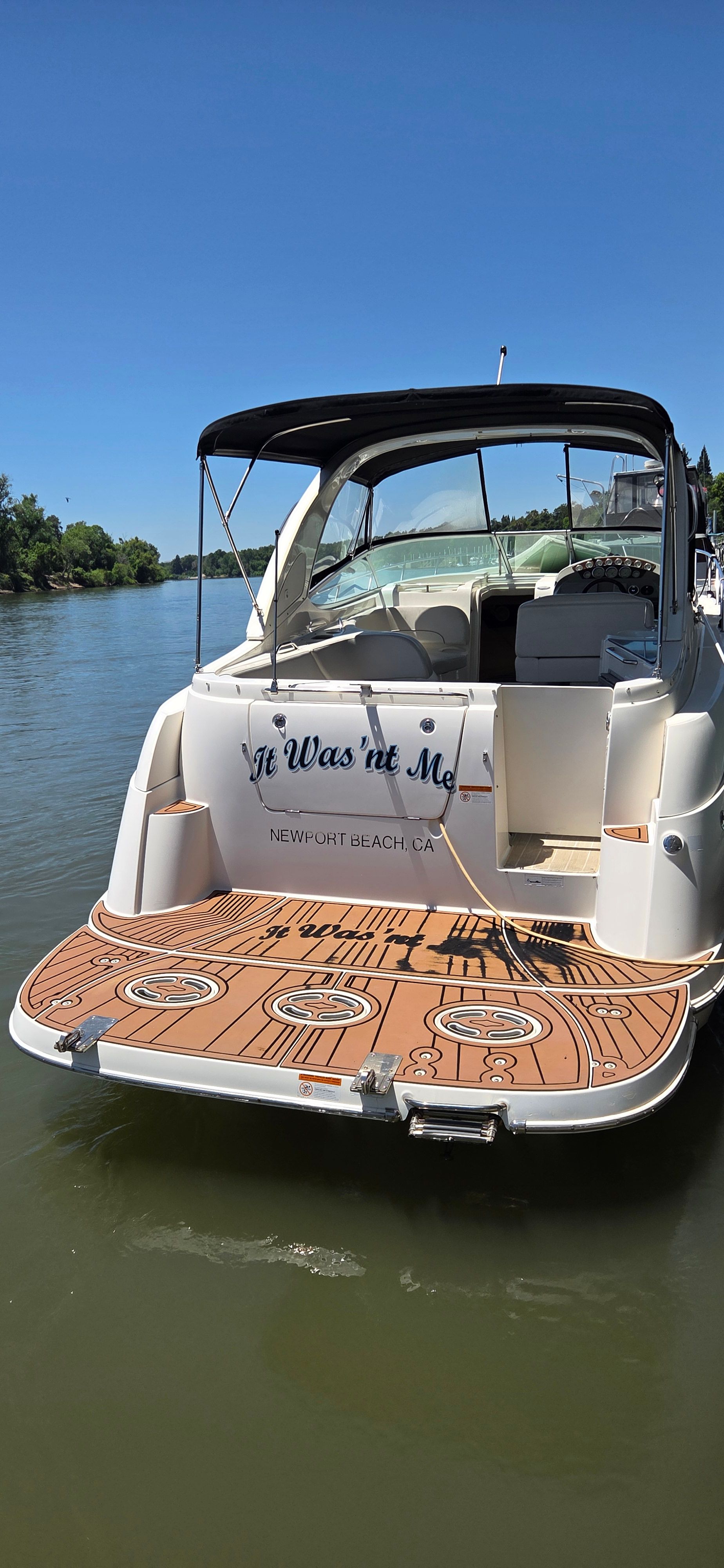 2012 Bayliner 335 Cruiser on a calm river.