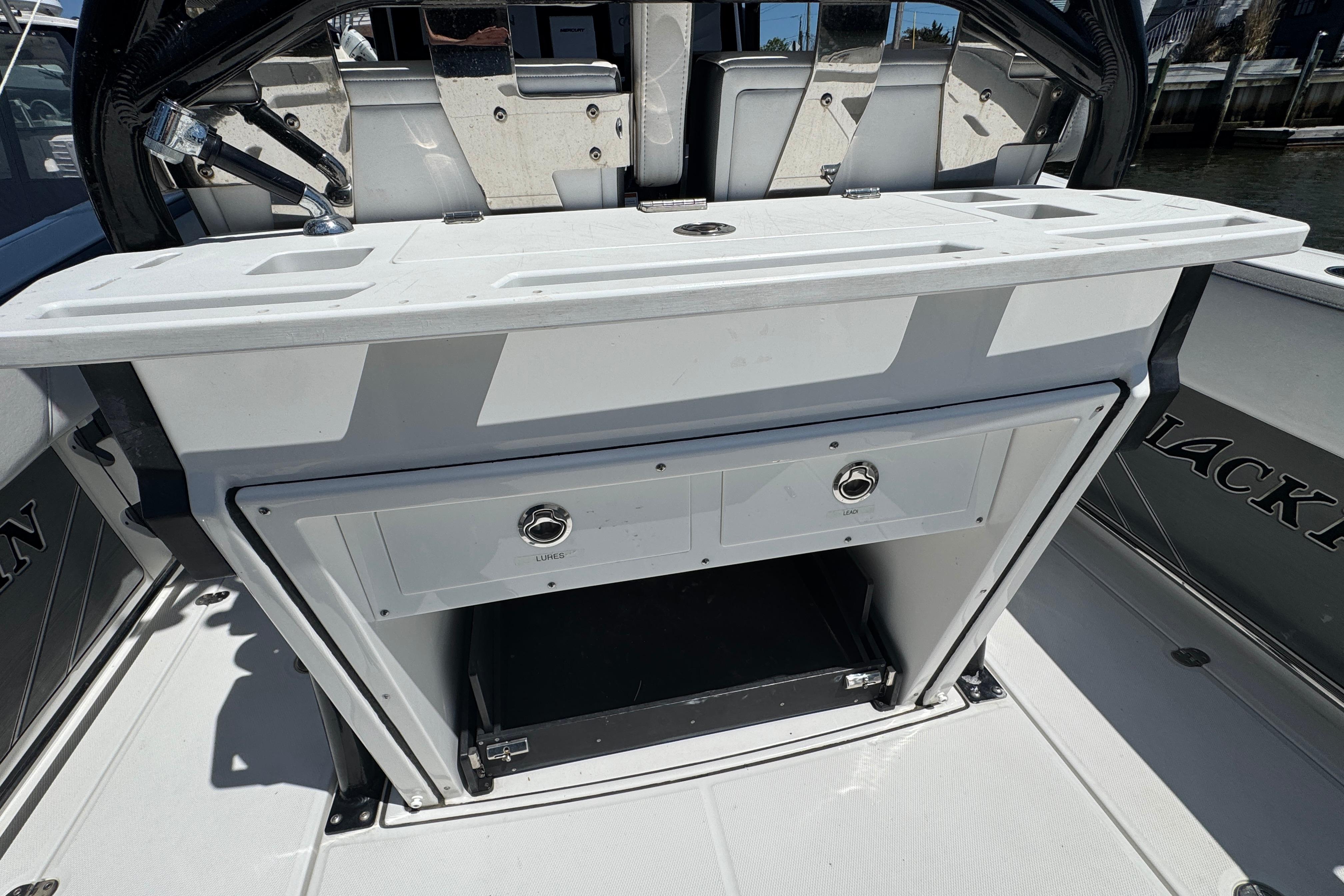 2020 Blackfin 272 CC boat interior with storage compartment and seating area.