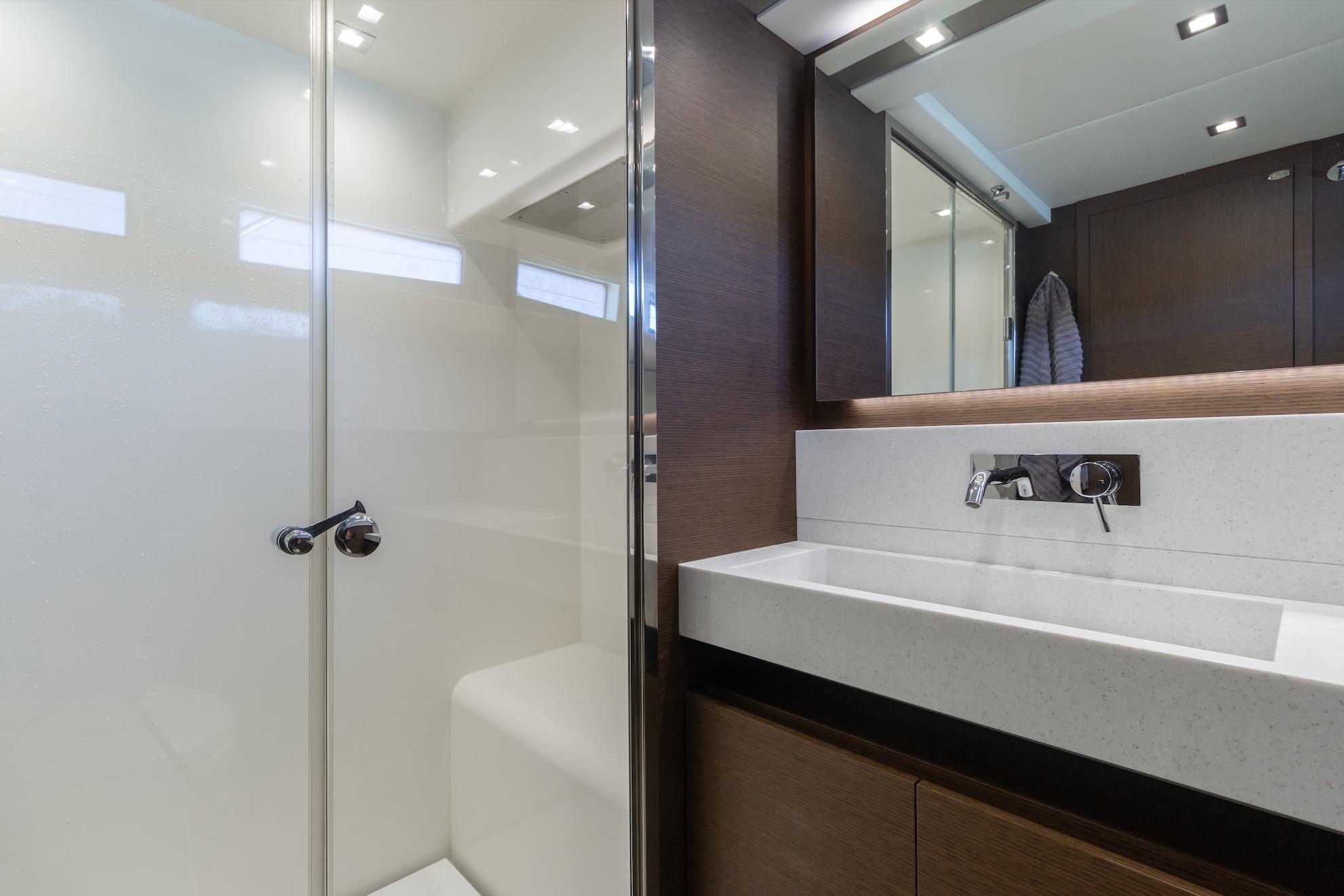 Luxurious bathroom interior of 2015 Prestige 750 yacht with modern fixtures and sleek design.