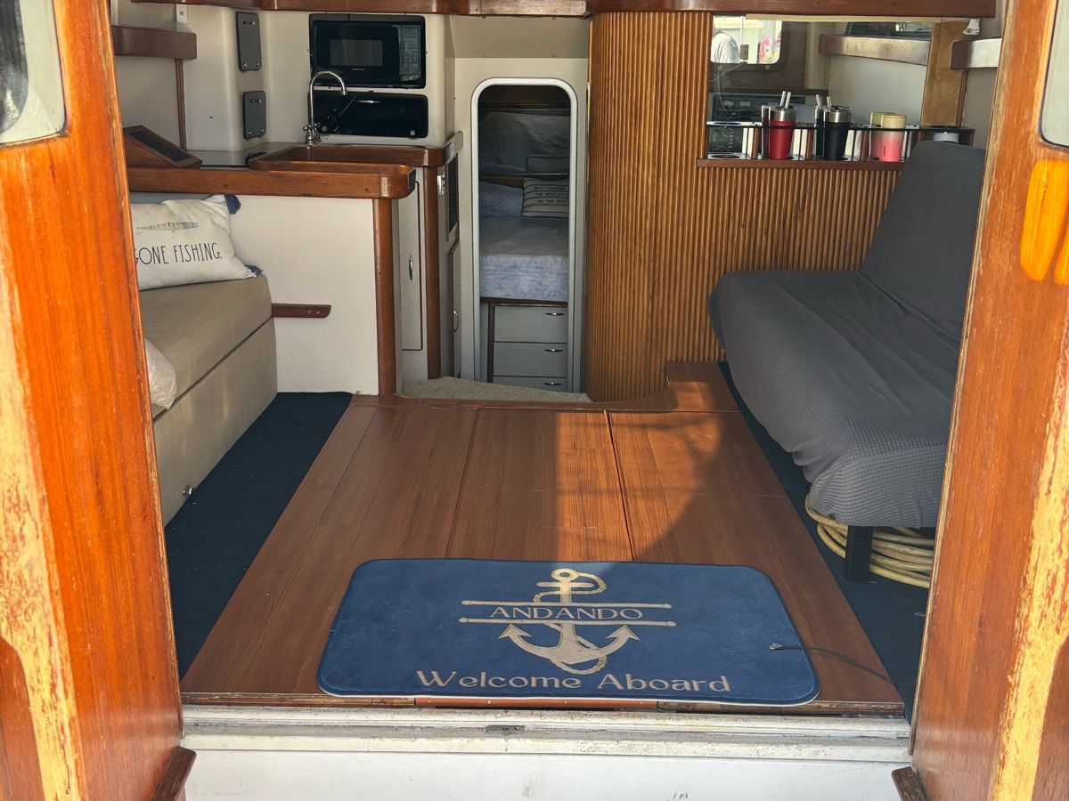 Interior of a 1994 Luhrs Convertible yacht with wooden flooring.