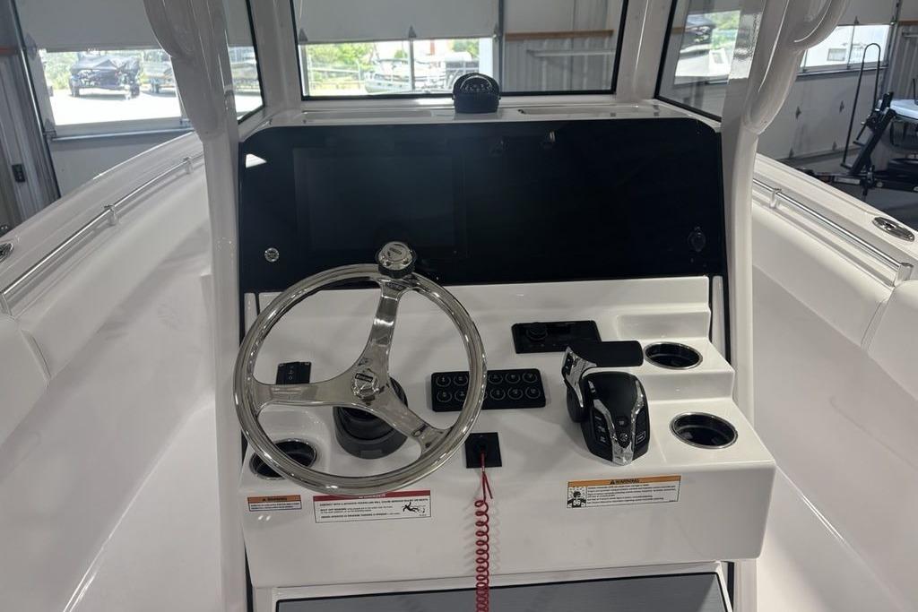 2026 Sportsman Open 252 Center Console helm with steering wheel and controls.