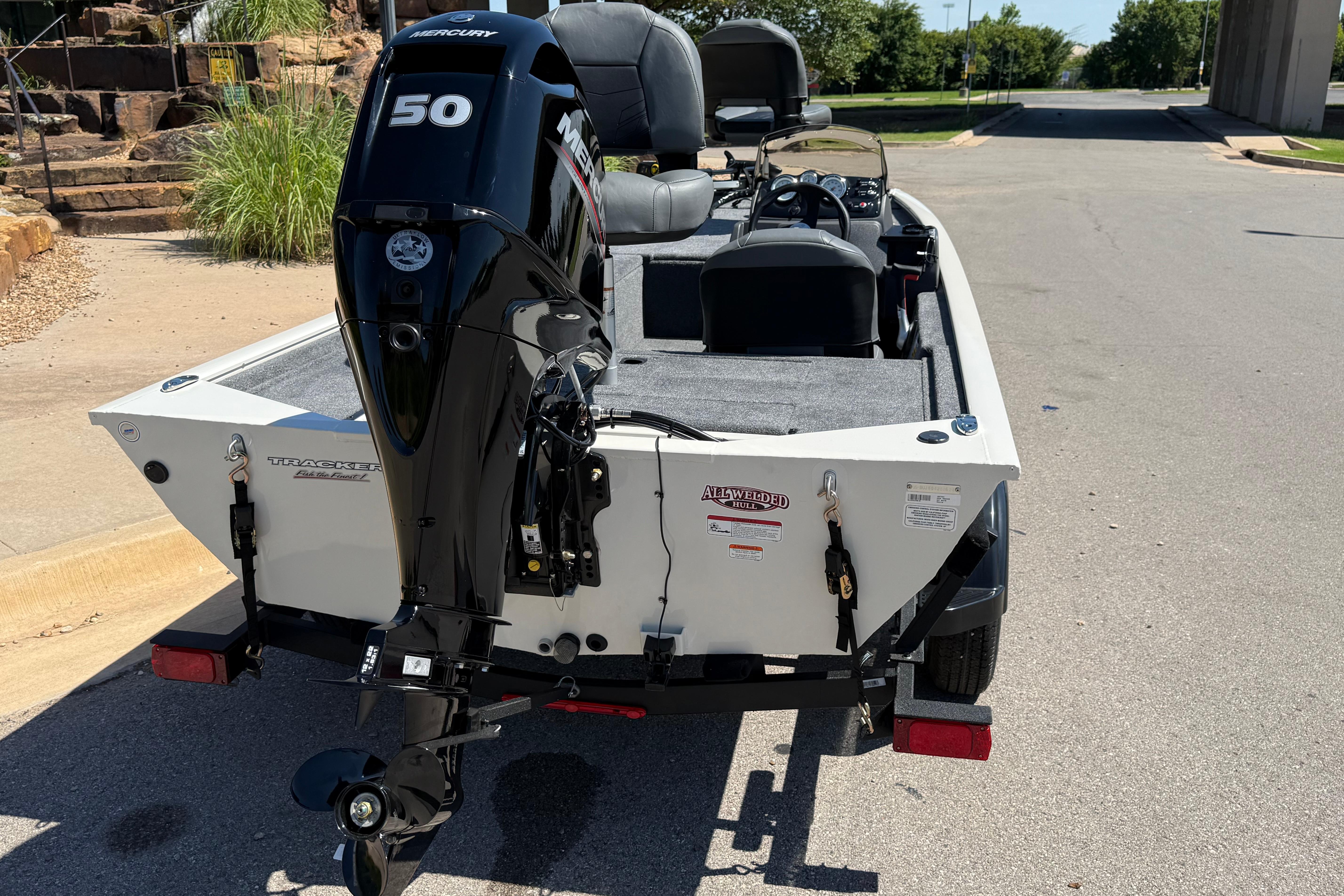 2026 Tracker Pro 170 boat with Mercury 50 engine, parked on a sunny street.