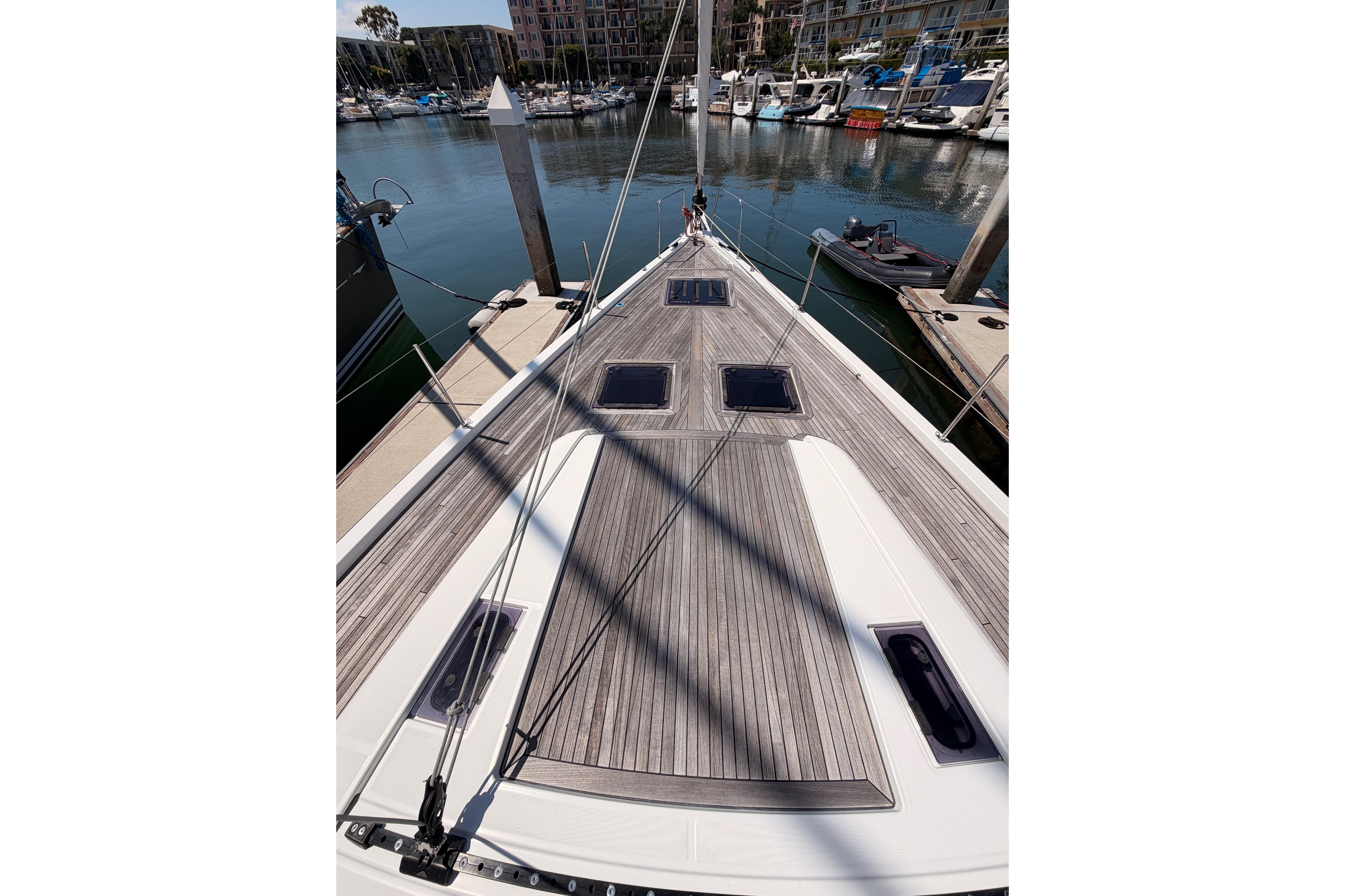 Deck view of 2022 Beneteau Oceanis Yacht 54 docked at marina.