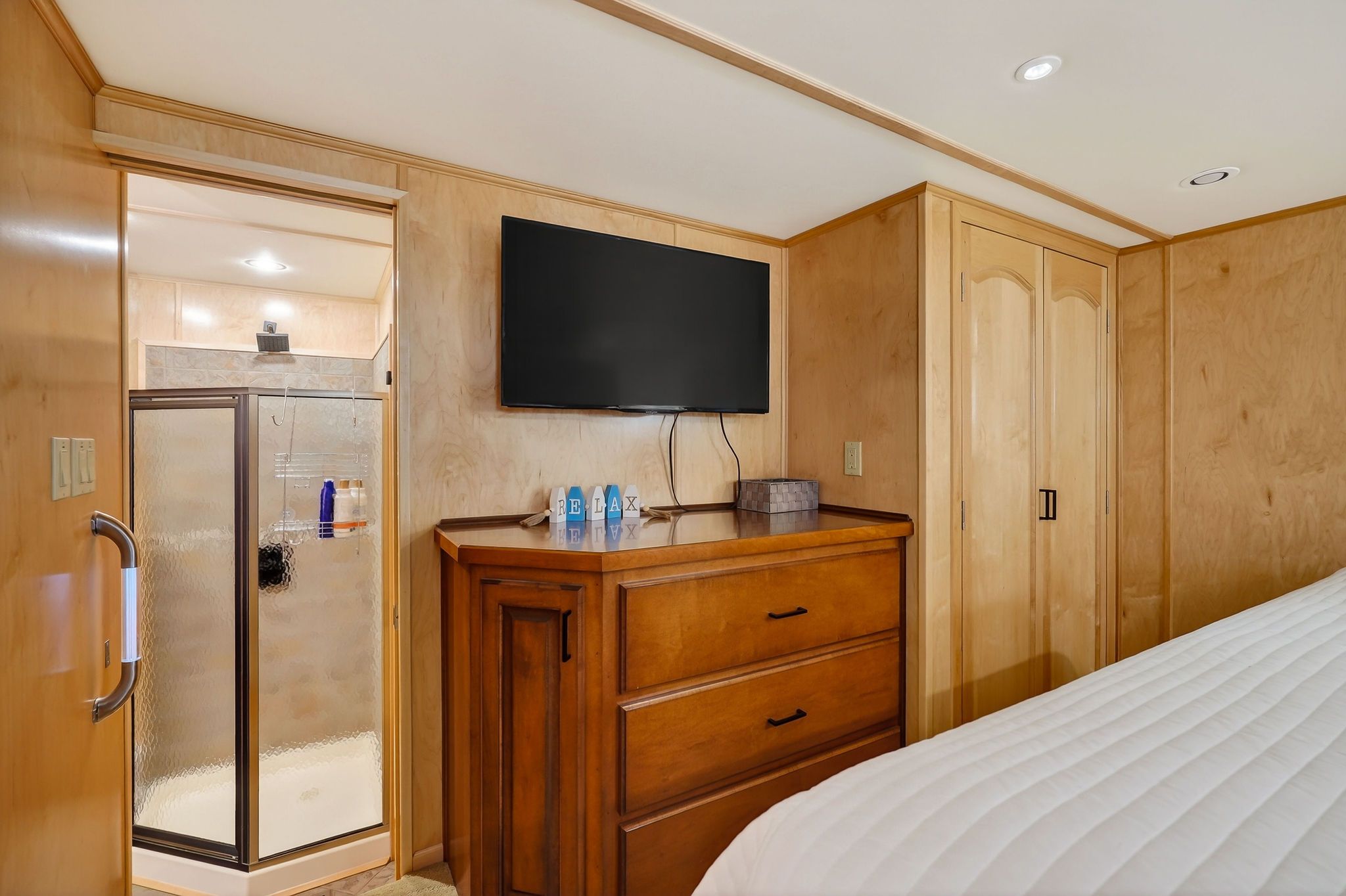 Interior of a 2010 Houseboat Throughbred cabin with shower and TV.