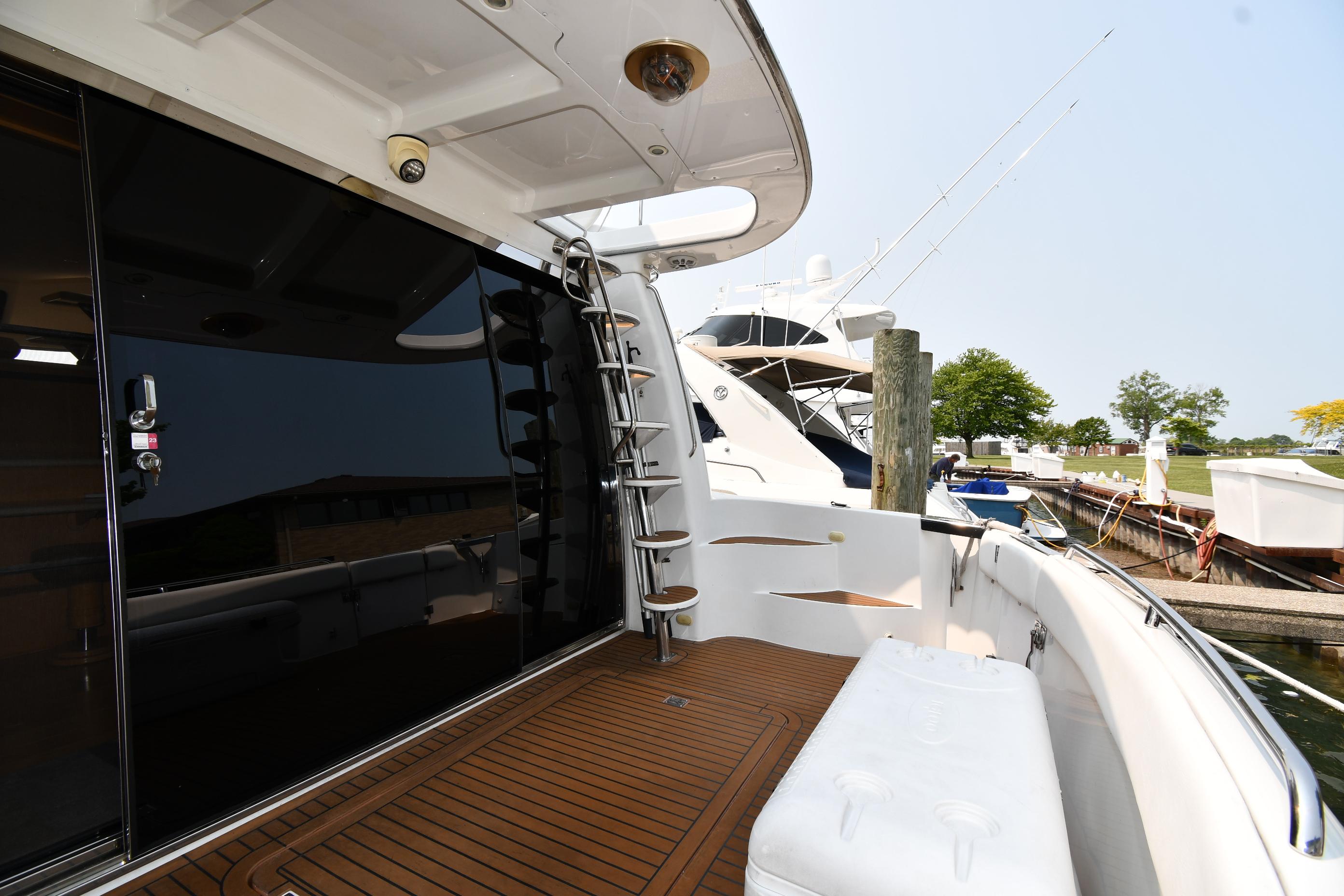 1998 Carver 530 Voyager Pilothouse yacht docked, featuring sleek design and spacious deck area.
