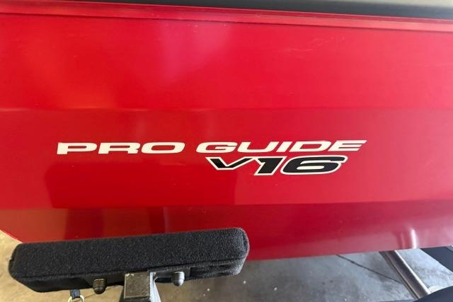 Red Tracker Pro Guide V-16 WT boat, model year 2026, side view.