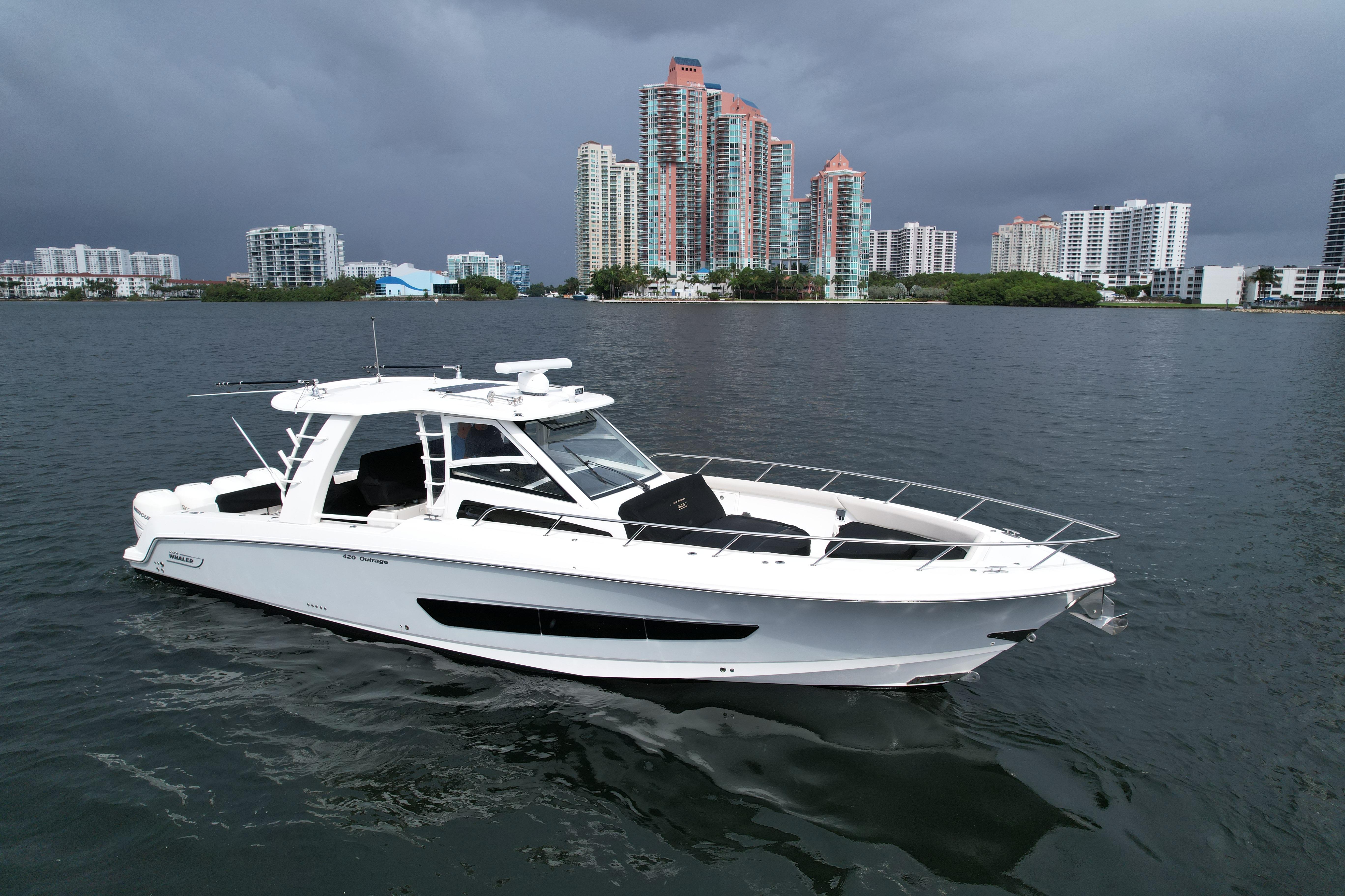 2020 Boston Whaler 420 Outrage boat on water with city skyline background.