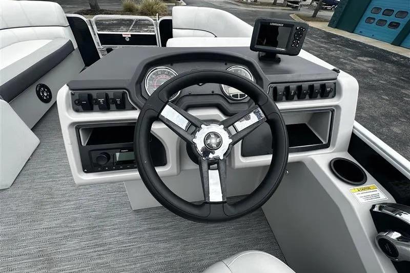 2023 Godfrey 2286 boat dashboard with steering wheel and navigation system.