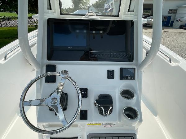 2025 Tidewater 232 CC Adventure boat console with steering wheel, controls, and display screens.