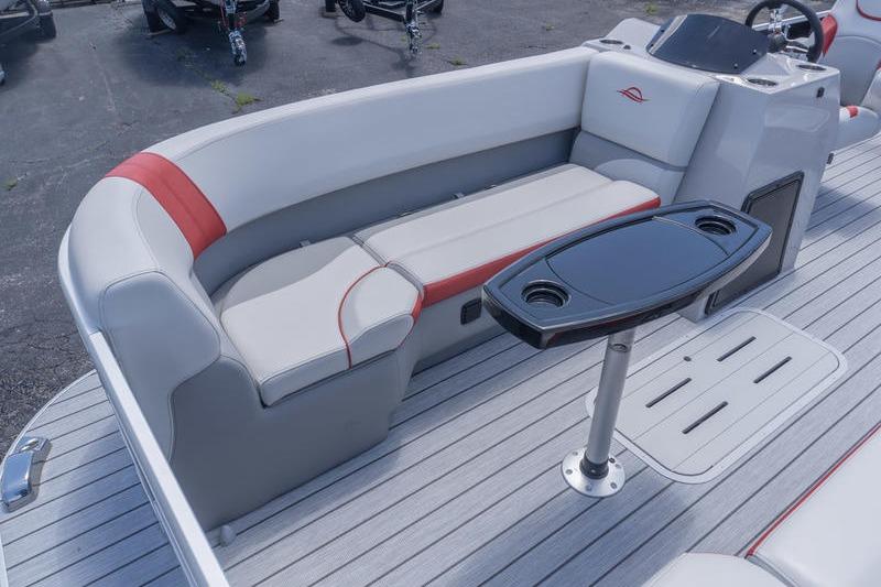 2026 SunCatcher Select 322SL boat interior with gray seating and a sleek table.