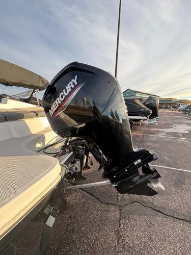 2023 Tahoe T16 boat with Mercury outboard motor in a parking lot.