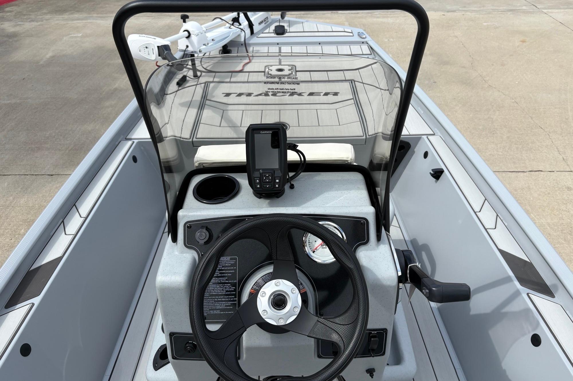 2026 Tracker Bass Tracker Classic CC boat console with steering wheel and navigation system.