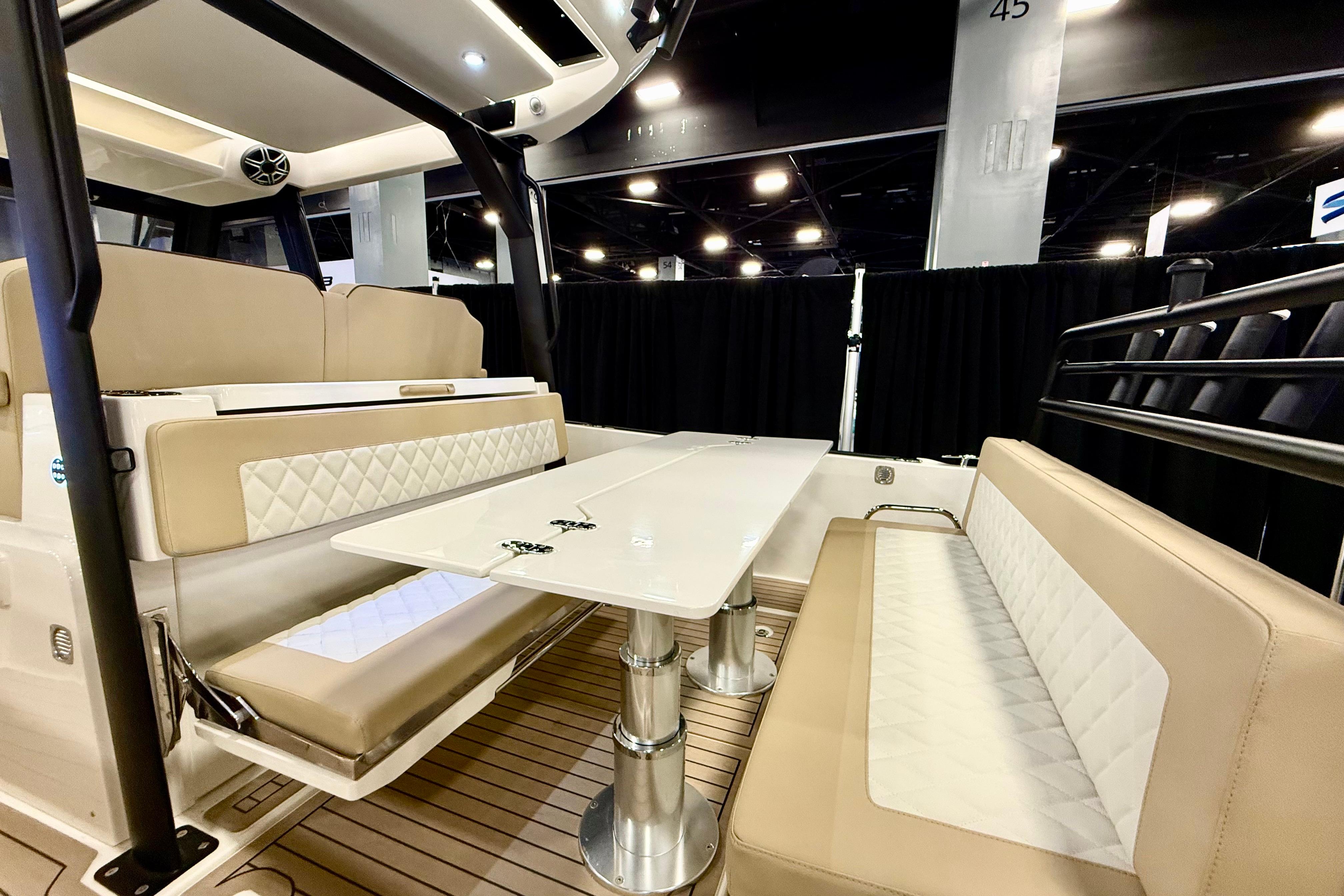 Luxurious interior of 2026 Zodiac X9CC boat with elegant seating and table.