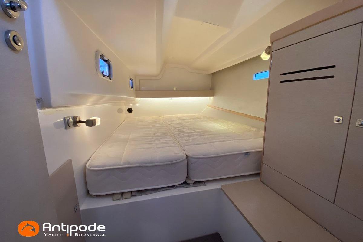 Cozy cabin interior of 2018 JPK 45 FC yacht with bed and storage.