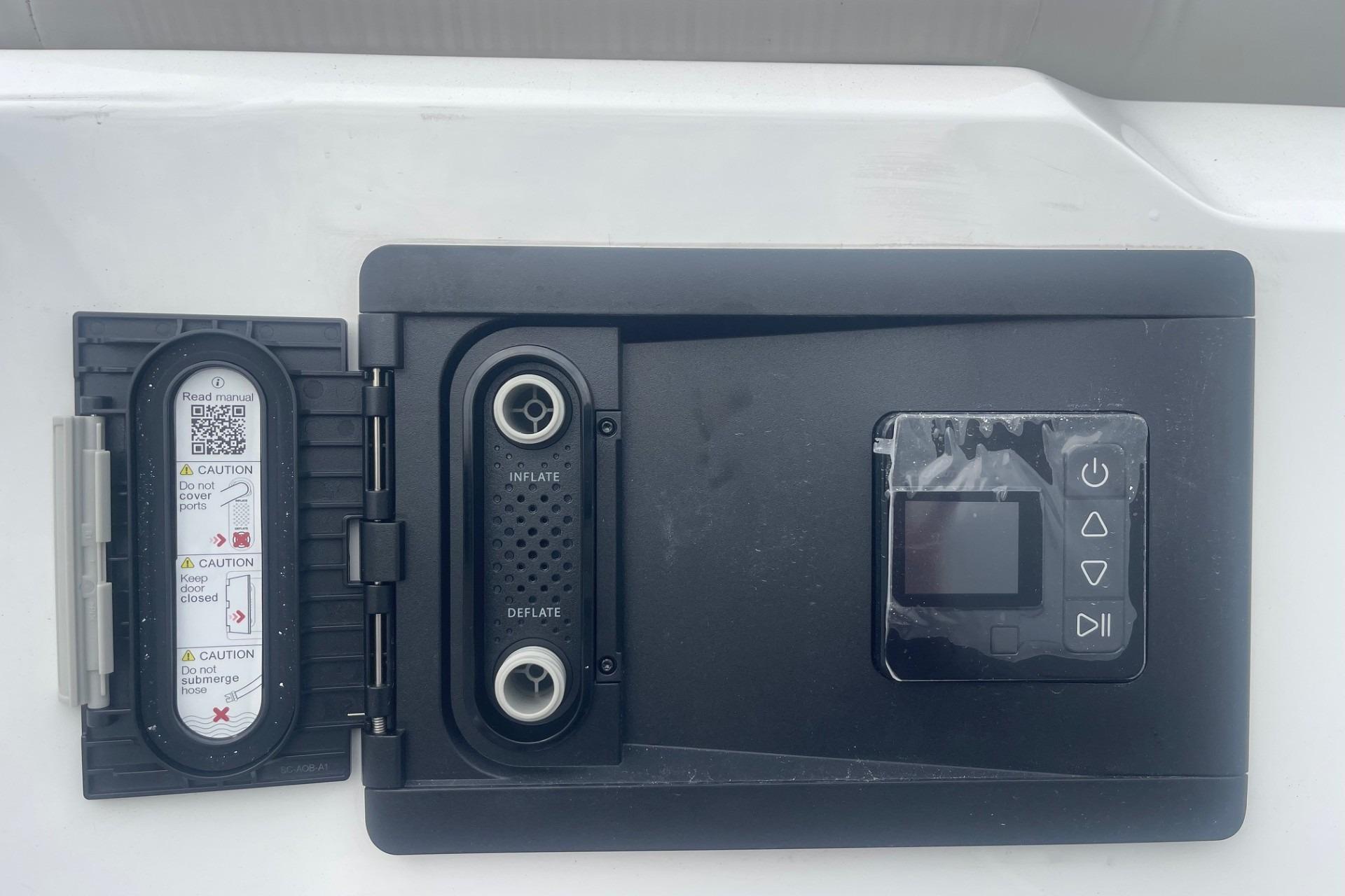 Control panel on 2025 Hurricane Center Console 24 OB boat, featuring inflate and deflate options.
