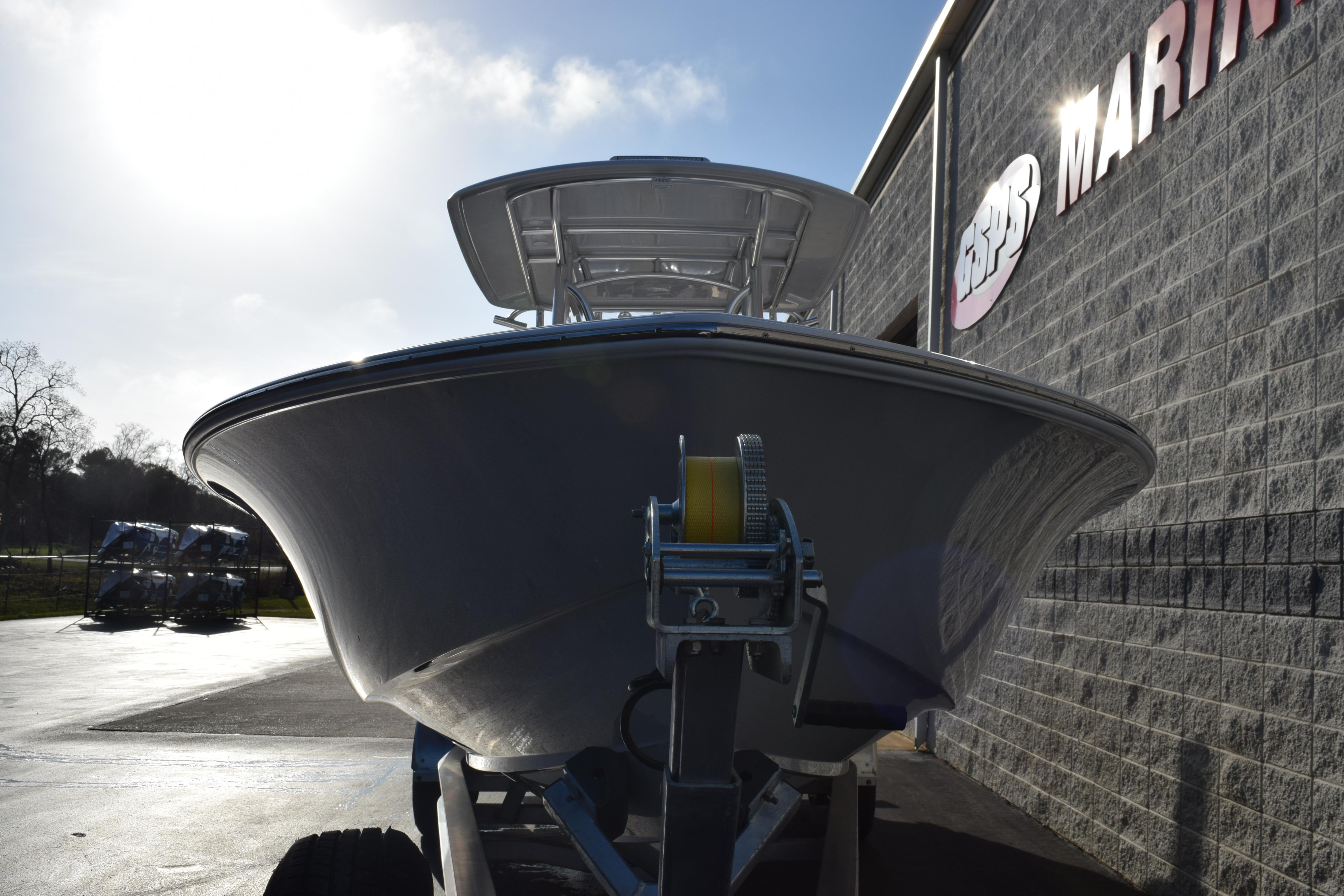 2026 Contender 29 Bay boat on trailer outside marine store.
