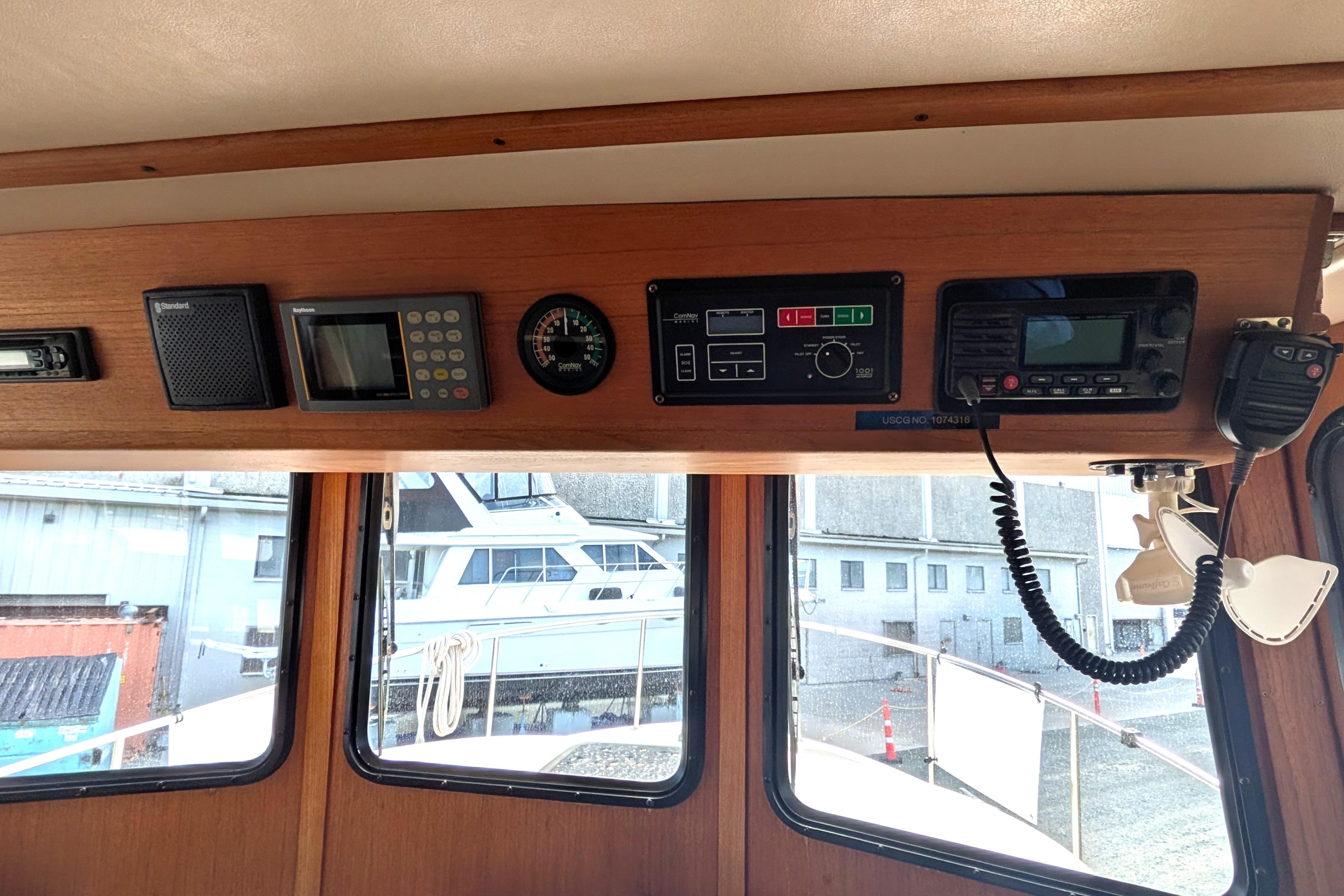 Interior dashboard of a 1998 Nordic Tug 32 with navigation and communication equipment.
