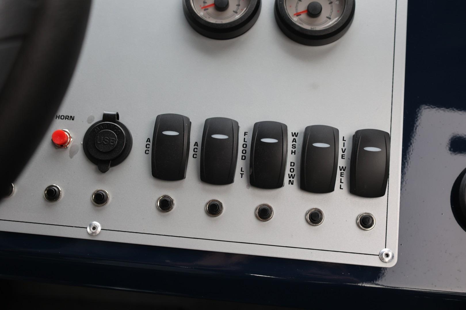 Control panel of 2026 Thunder Jet 24 Alexis Pro boat with switches and gauges.