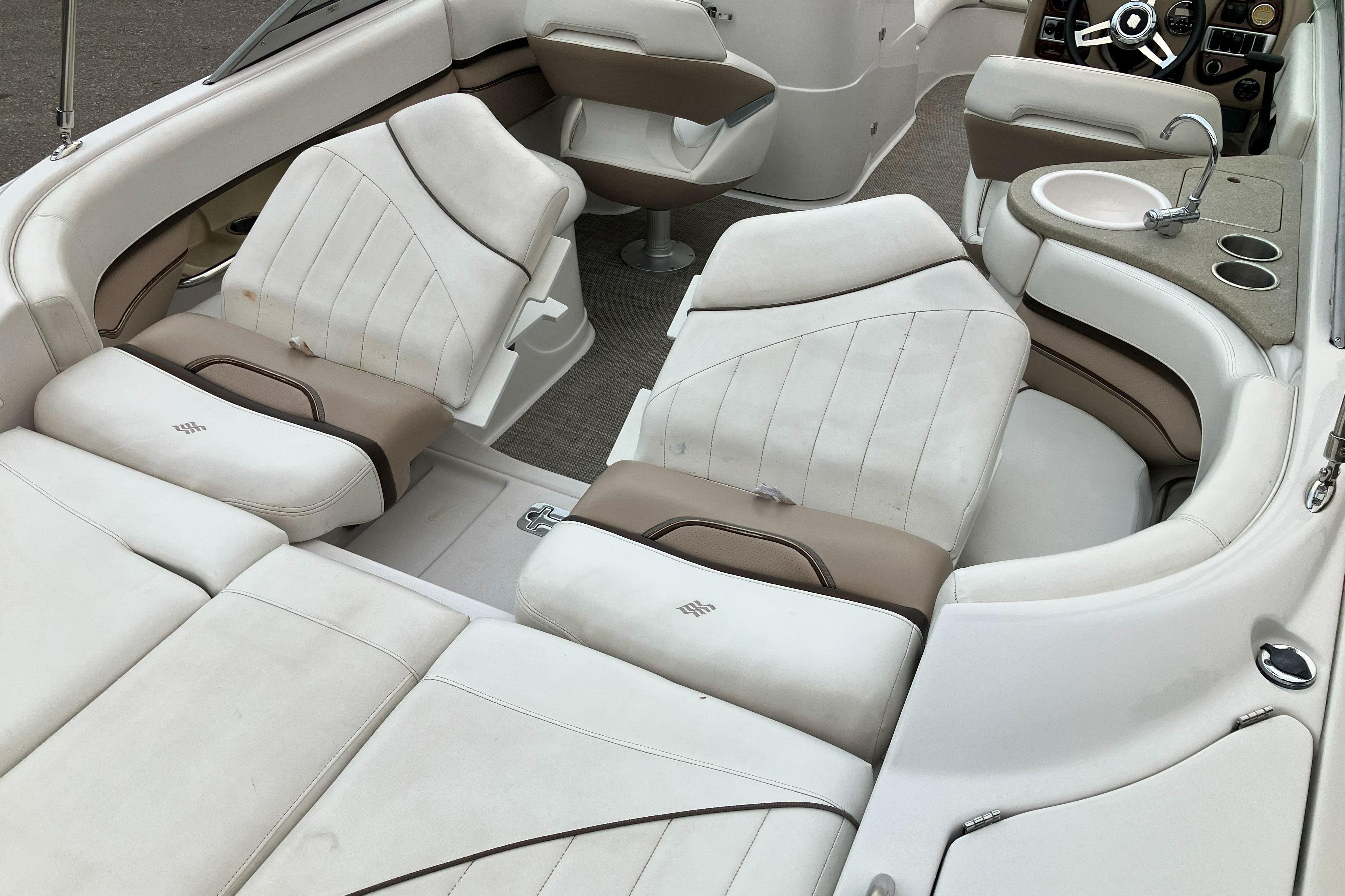 2006 Four Winns 240 Horizon boat interior with white seating and built-in sink.