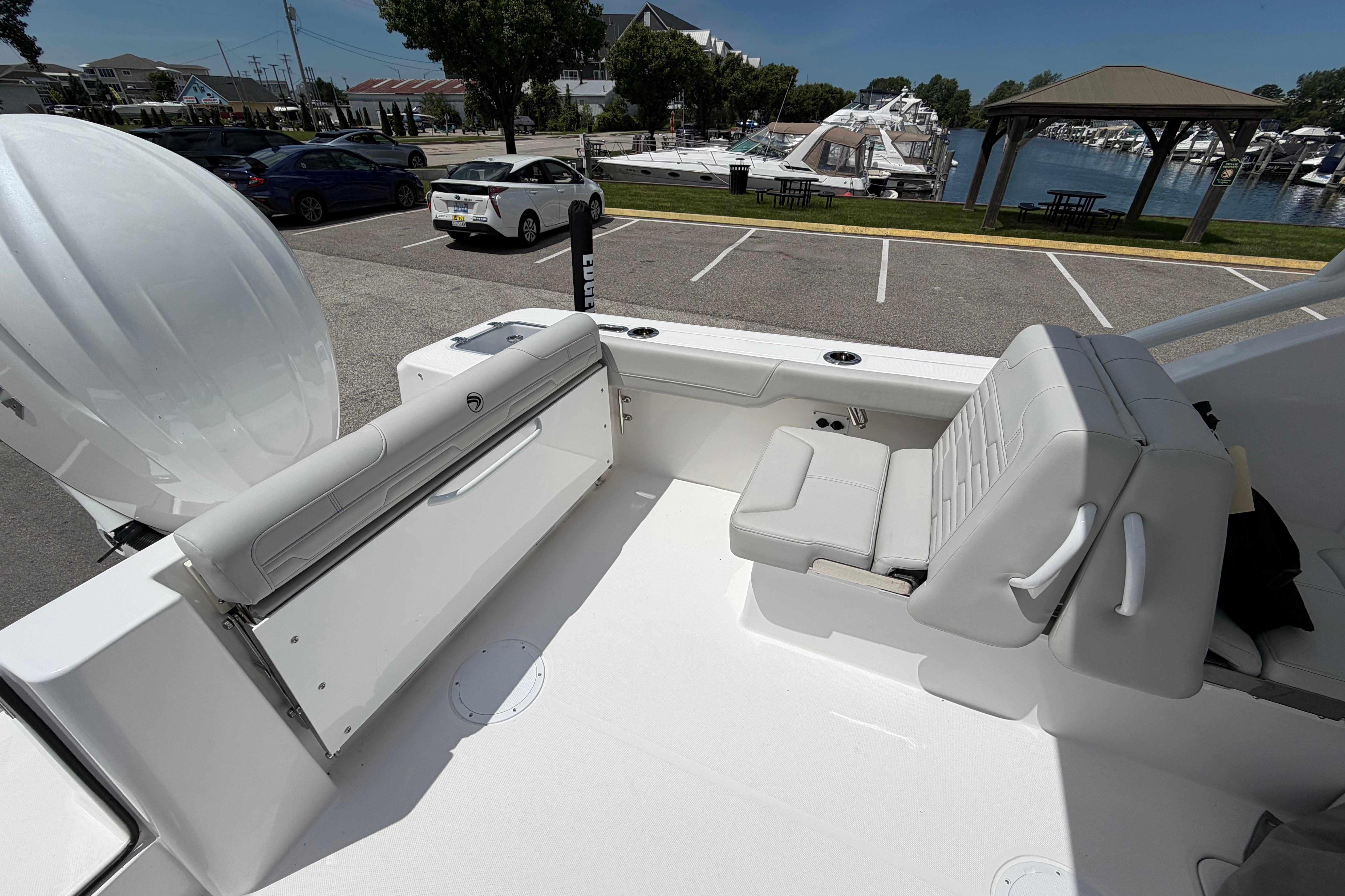 2026 Edgewater 248CX Crossover boat interior with seating, parked near marina.
