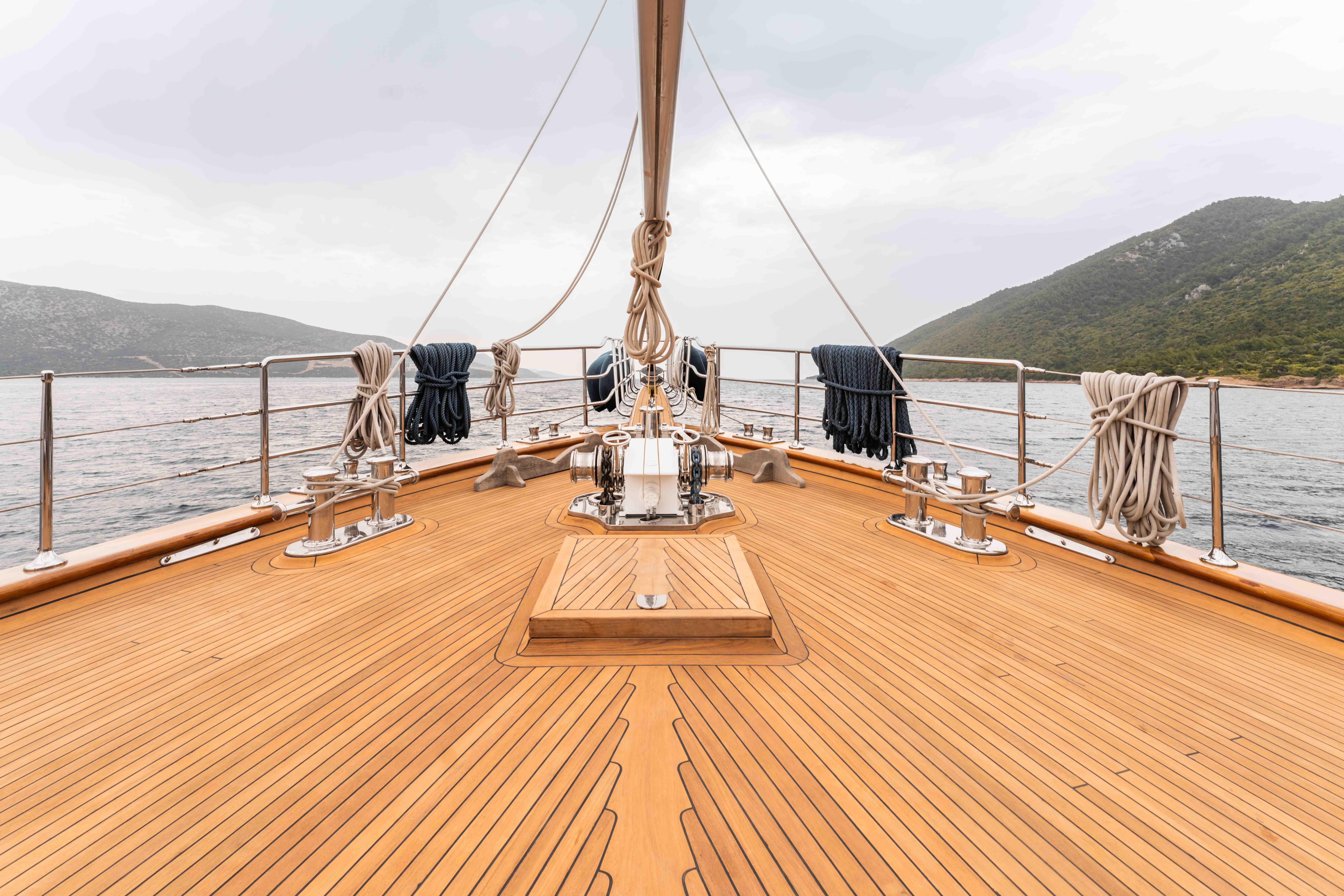 Custom 2009 sailing yacht with teak deck, cruising in scenic waters.