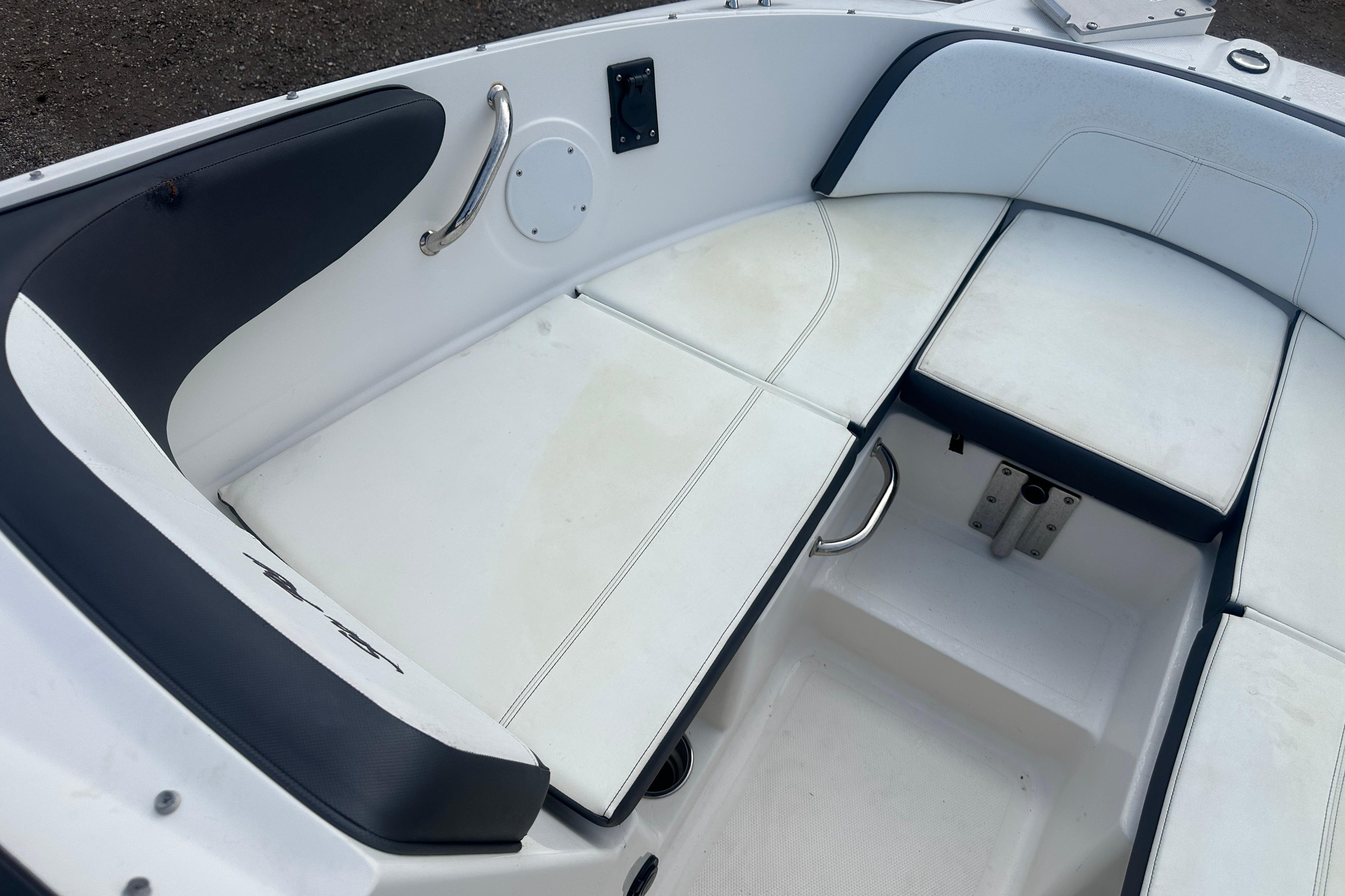 2017 Sea Ray SPX 190 Outboard boat interior with white cushioned seating.