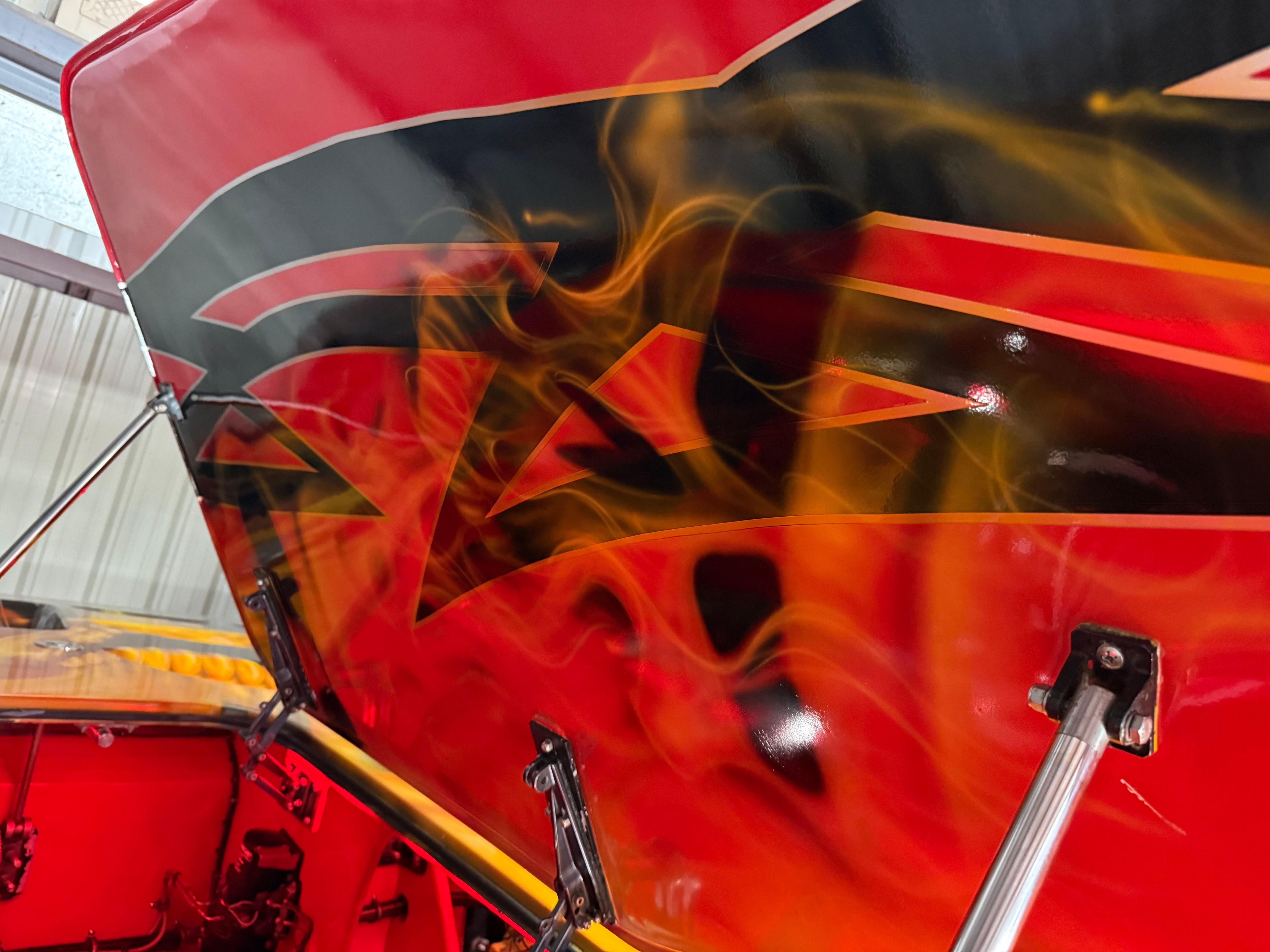 The image shows the interior of a 2010 MTI CAT with striking flame design.